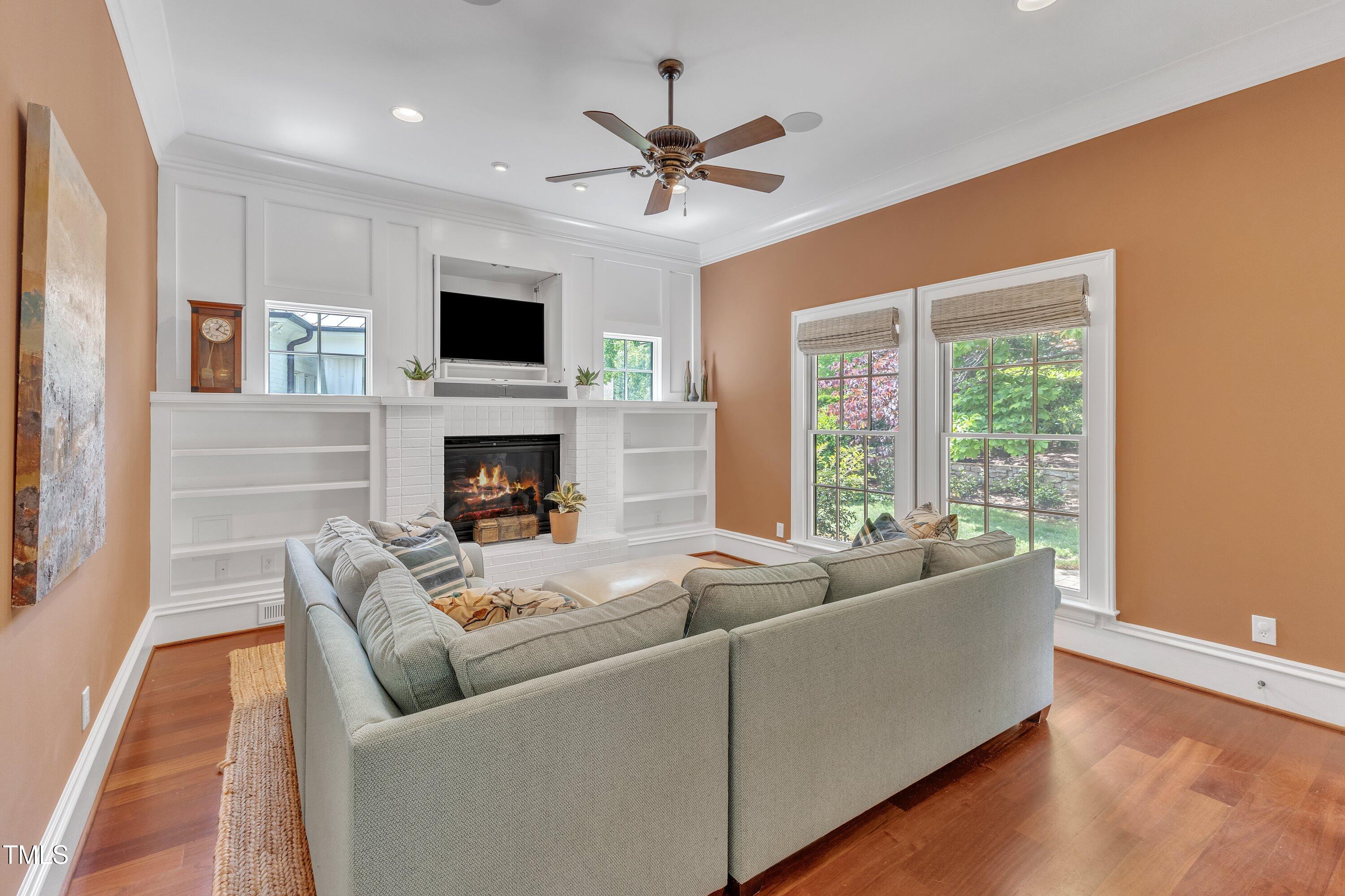 2117 Buckingham Road Raleigh, NC 27607 - Photo 21 of 82 a living room with furniture fireplace and a flat screen tv