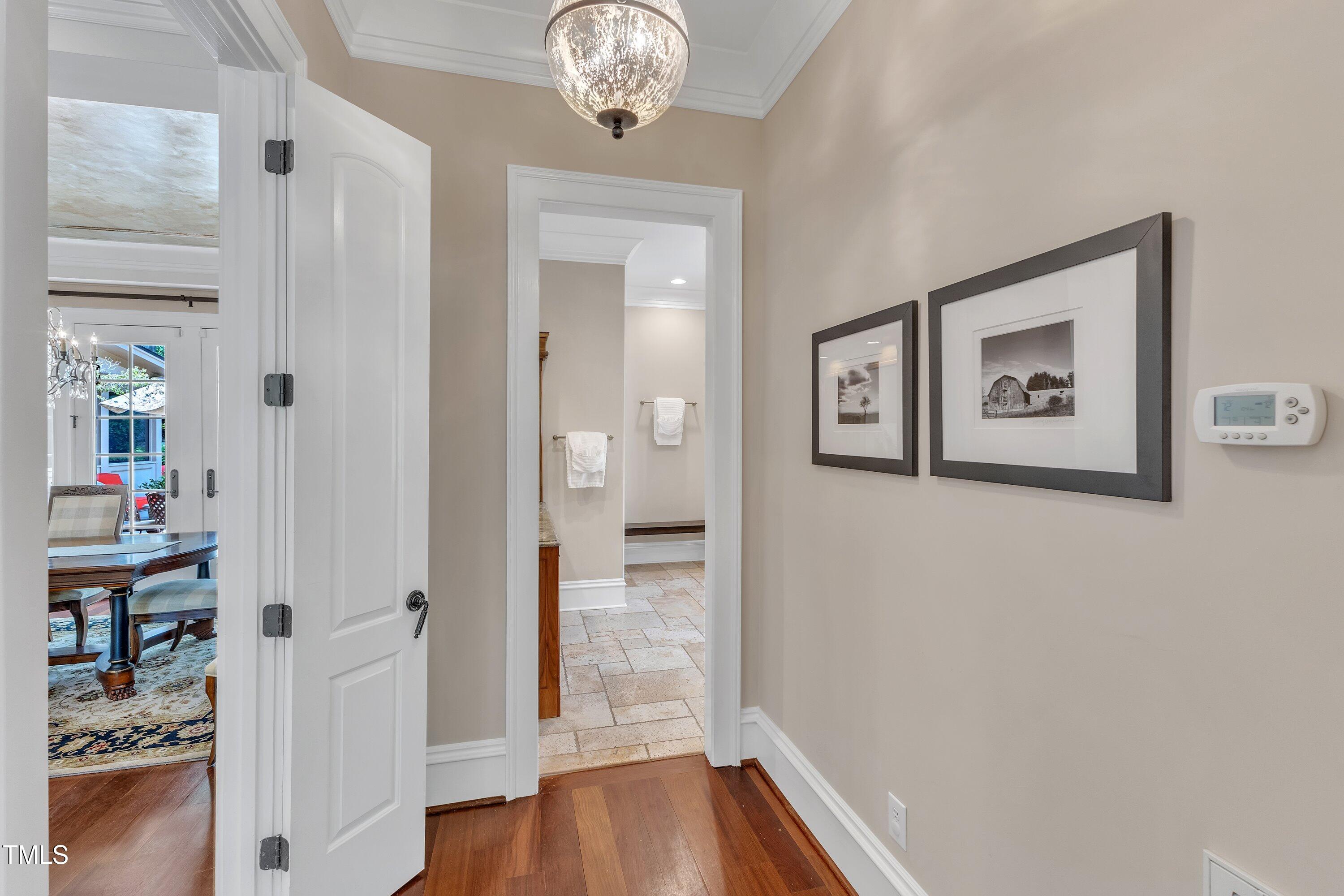 2117 Buckingham Road Raleigh, NC 27607 - Photo 26 of 82 a view of a hallway with wooden floor and a bathroom