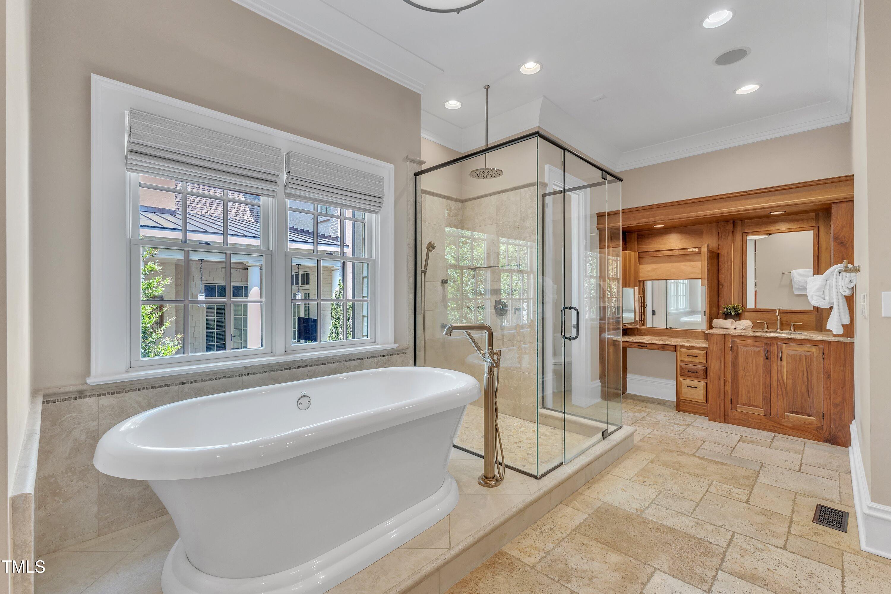 2117 Buckingham Road Raleigh, NC 27607 - Photo 28 of 82 a bathroom with a tub a sink a mirror and a shower