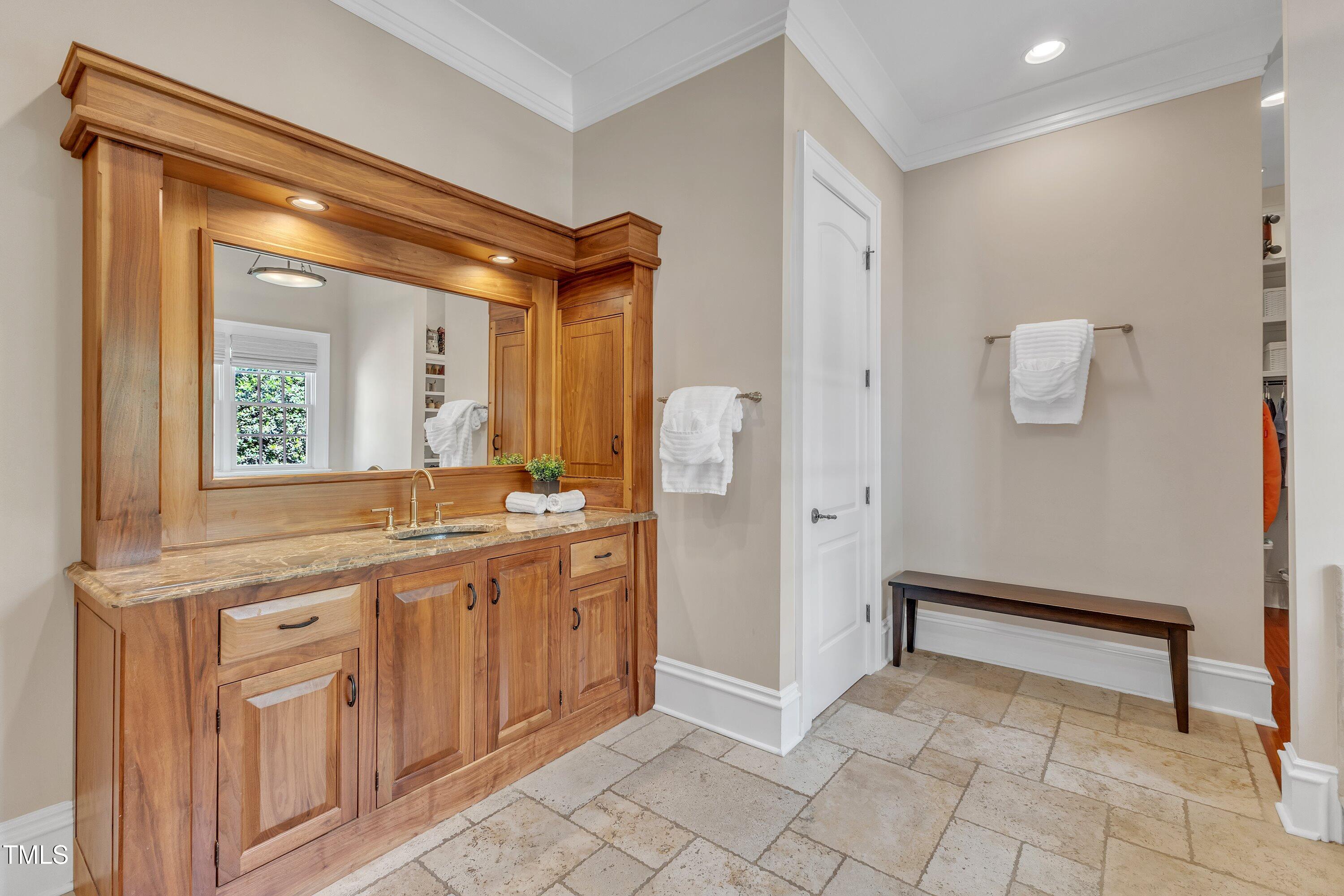 2117 Buckingham Road Raleigh, NC 27607 - Photo 29 of 82 a spacious bathroom with a mirror a sink and a shower