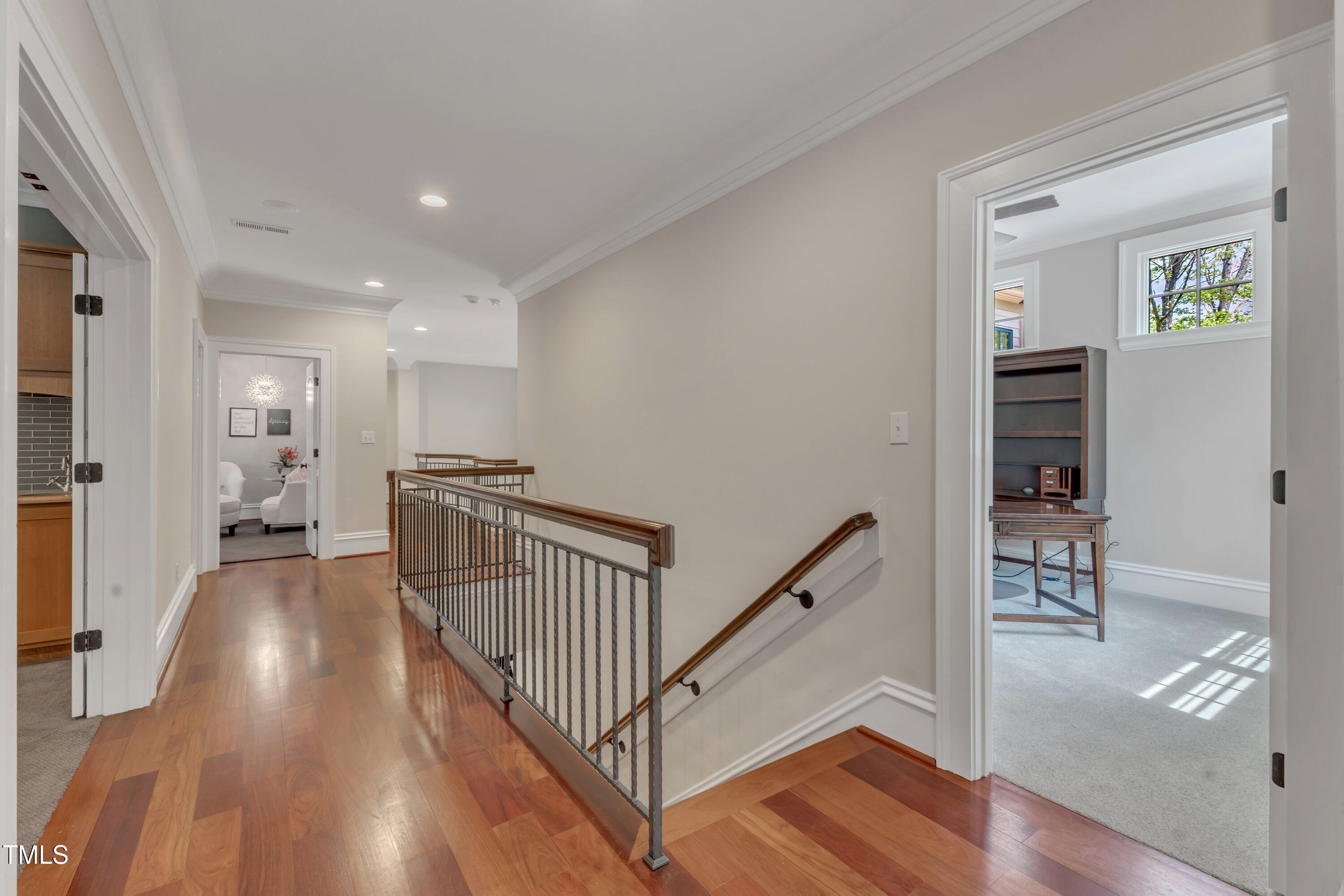 2117 Buckingham Road Raleigh, NC 27607 - Photo 35 of 82 a view of a hallway with wooden floor and windows
