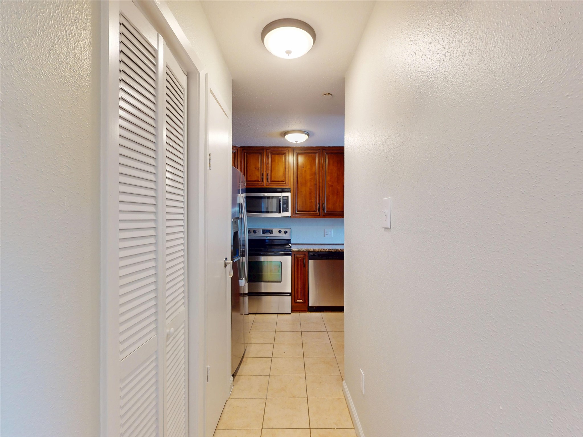 793 Davis Road, Unit 111 League City, TX 77573 - Photo 3 of 16 Just to left of front entrance is entry to kitchen with gleaming wood cabinetry. Louvered doors conceal a stacked clothes washer & dryer.