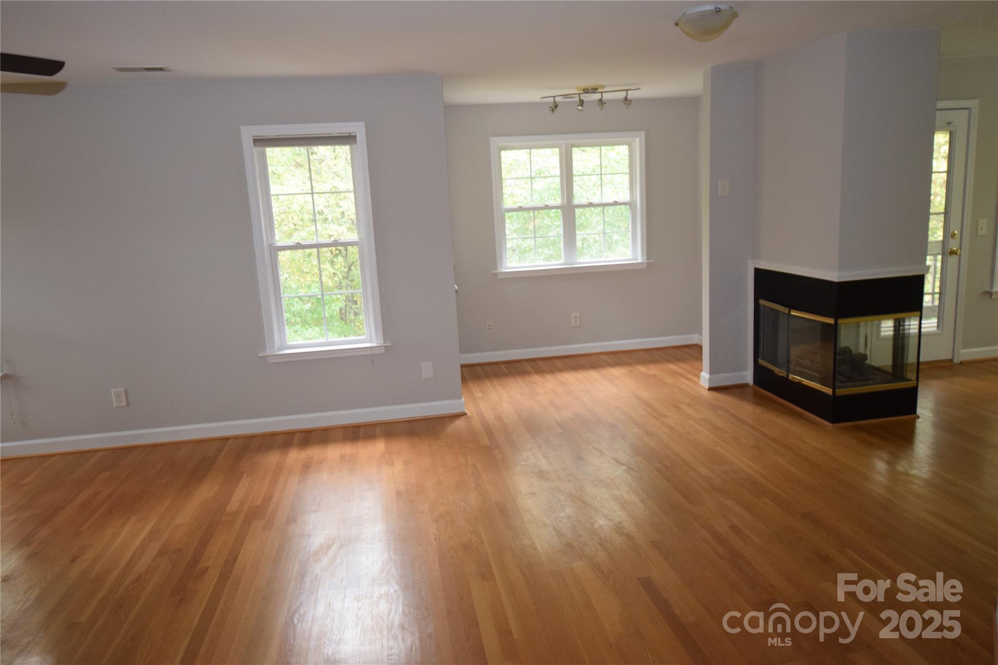 809 Pine Forest Road Charlotte, NC 28214 - Photo 14 of 36 a view of an empty room with wooden floor and a window