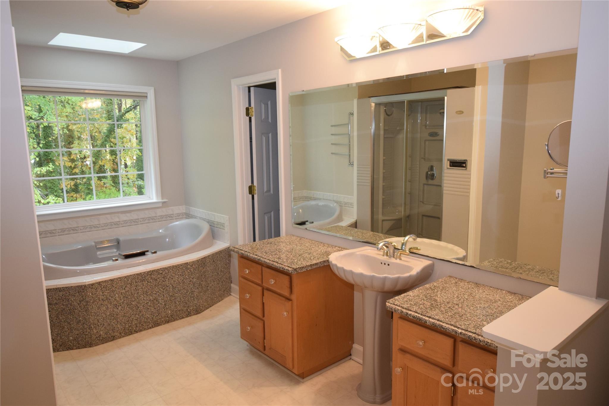 809 Pine Forest Road Charlotte, NC 28214 - Photo 18 of 36 a bathroom with a tub sink and mirror