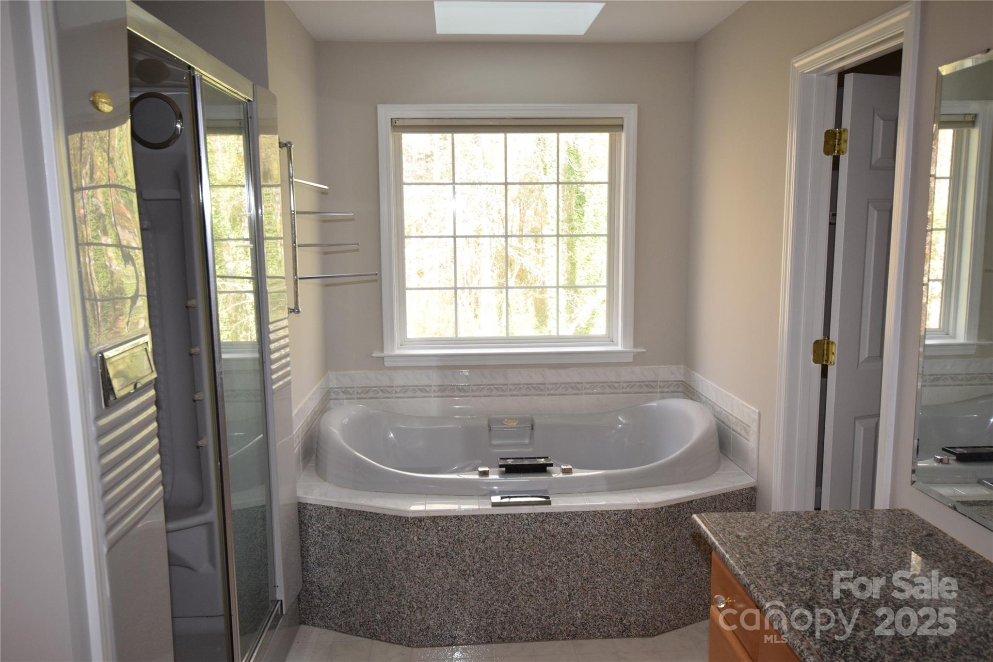 809 Pine Forest Road Charlotte, NC 28214 - Photo 19 of 36 a white bath tub sitting in a bathroom next to a window