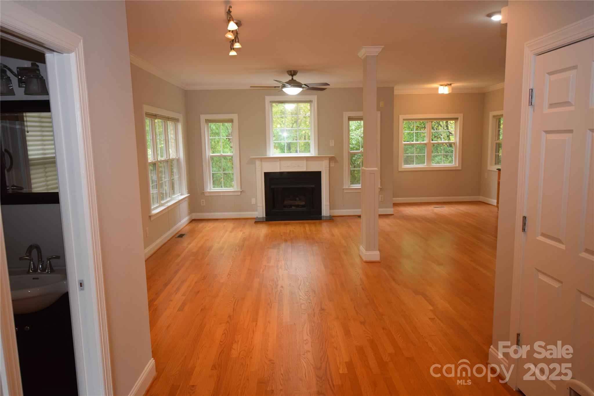 809 Pine Forest Road Charlotte, NC 28214 - Photo 2 of 36 a view of an empty room with window and wooden floor