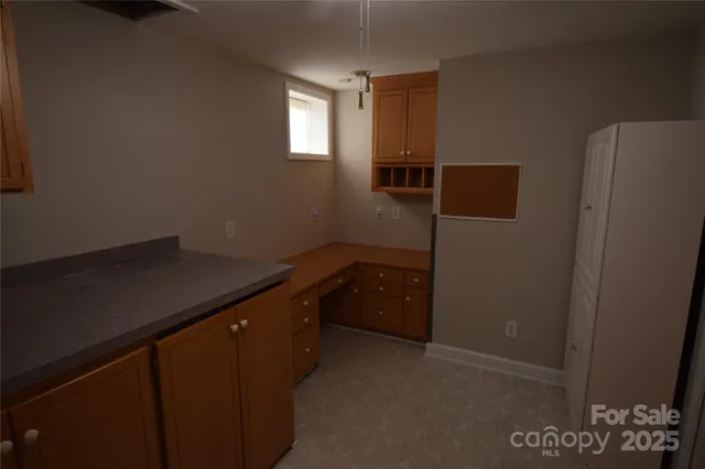 a kitchen with a refrigerator and window
