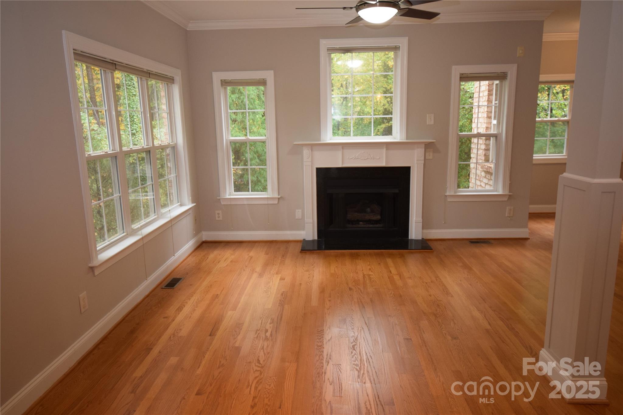 809 Pine Forest Road Charlotte, NC 28214 - Photo 3 of 36 a view of an empty room with wooden floor and a window