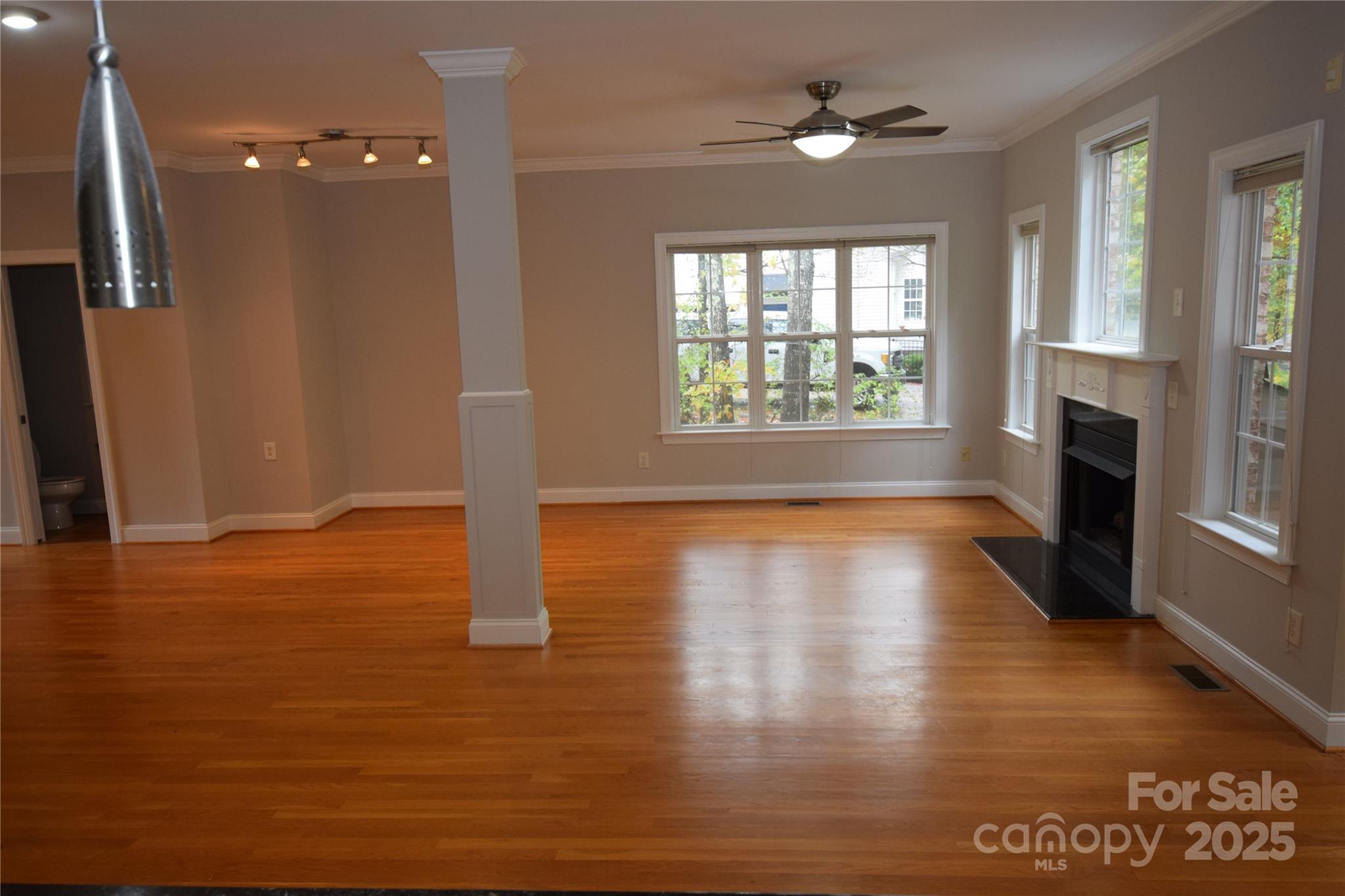 809 Pine Forest Road Charlotte, NC 28214 - Photo 5 of 36 a view of empty room with wooden floor and fan