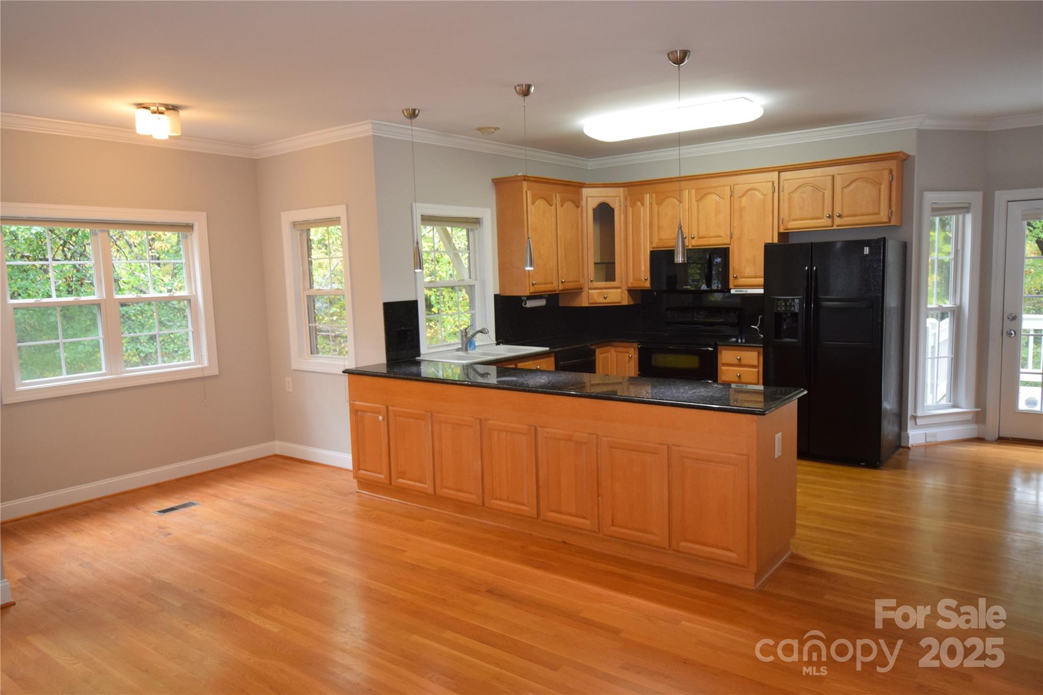 809 Pine Forest Road Charlotte, NC 28214 - Photo 6 of 36 a kitchen with stainless steel appliances granite countertop a refrigerator a stove top oven and a large window