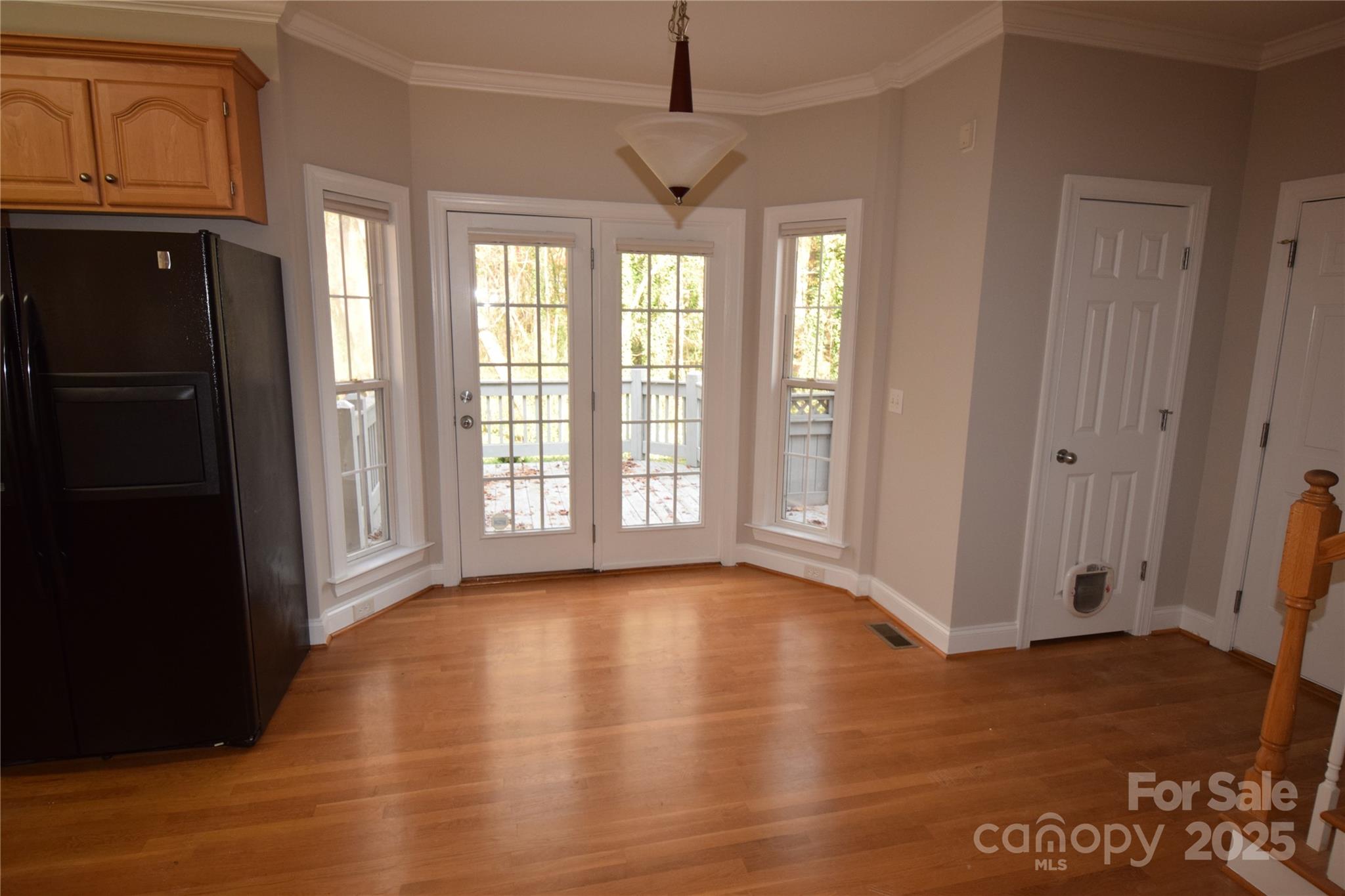 809 Pine Forest Road Charlotte, NC 28214 - Photo 7 of 36 a view of an empty room with window and wooden floor