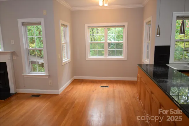 a view of a room with wooden floor and a window