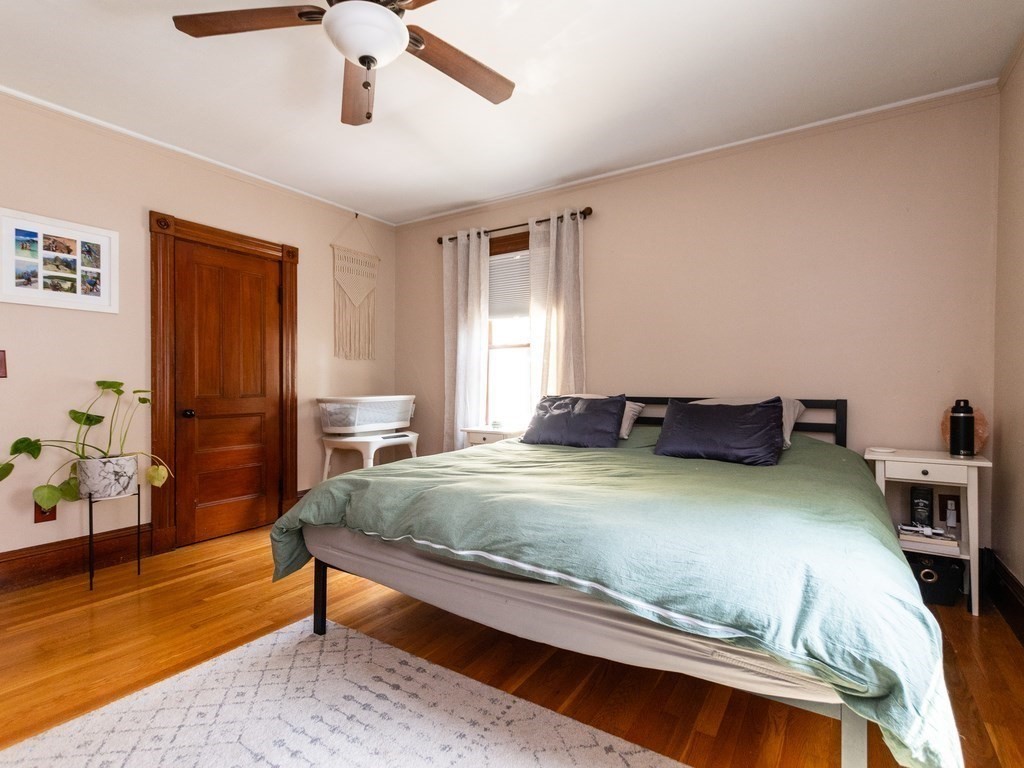 16 Alexander Street Framingham, MA 01702 - Photo 25 of 41 a bedroom with a bed and wooden floor