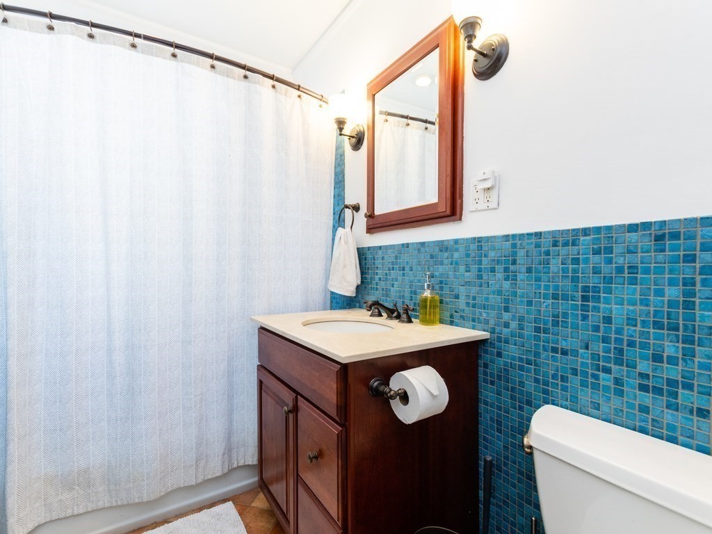 16 Alexander Street Framingham, MA 01702 - Photo 31 of 41 a bathroom with a sink a toilet and a mirror