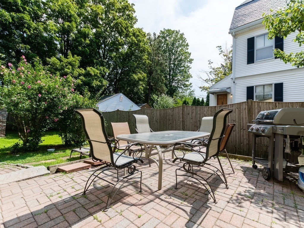 16 Alexander Street Framingham, MA 01702 - Photo 36 of 41 a view of a chairs and table in patio with a fire pit