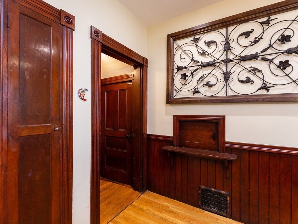 16 Alexander Street Framingham, MA 01702 - Photo 8 of 41 a view of a hallway with wooden floor and a cabinet