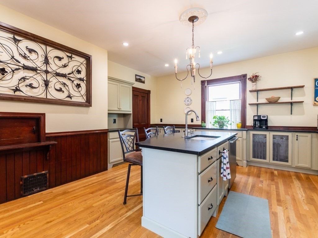 16 Alexander Street Framingham, MA 01702 - Photo 9 of 41 a kitchen with stainless steel appliances granite countertop a sink stove and wooden floor