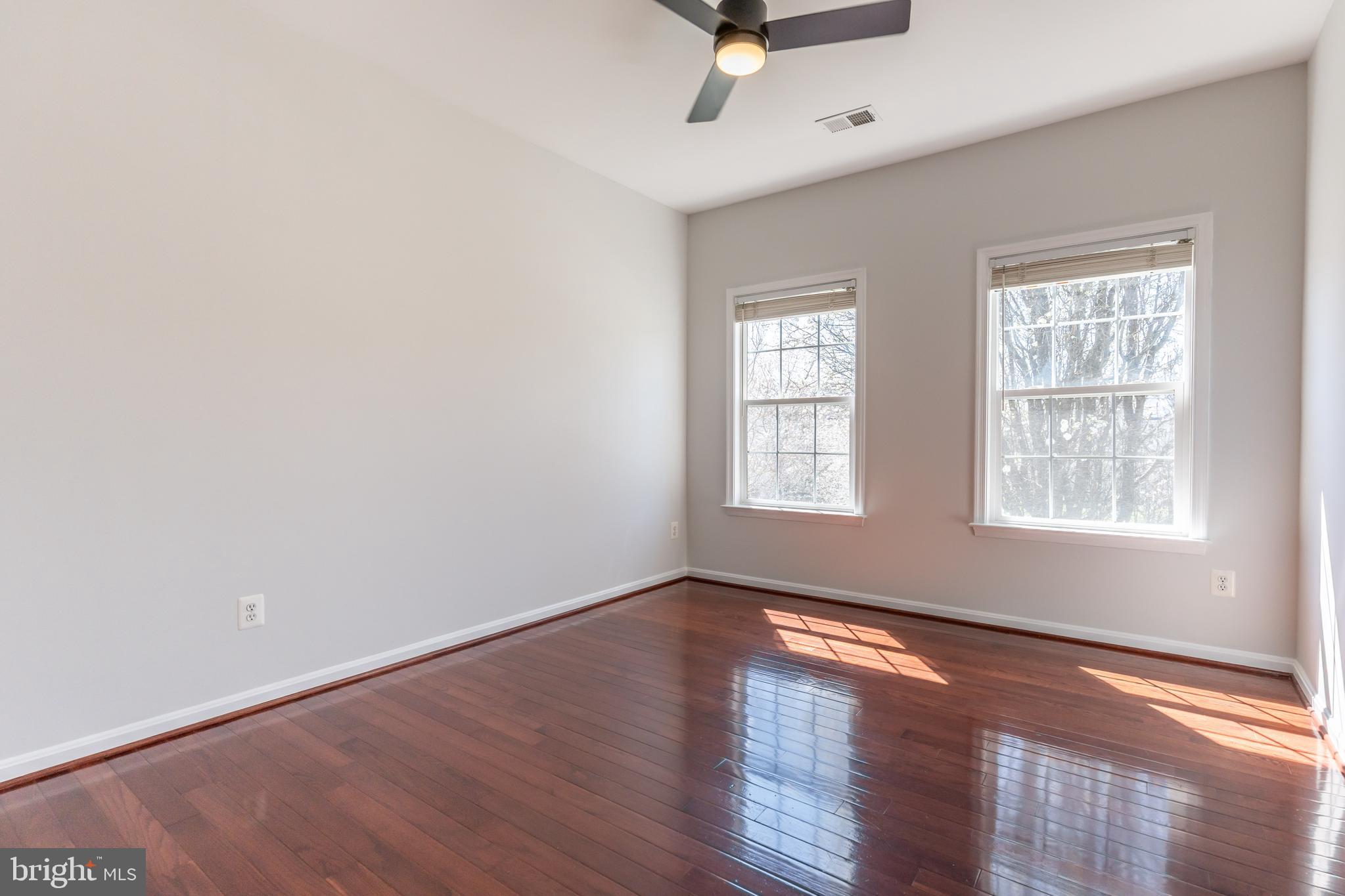 12675 Rushing Creek Court Bristow, VA 20136 - Photo 11 of 49 wooden floor in an empty room with a window