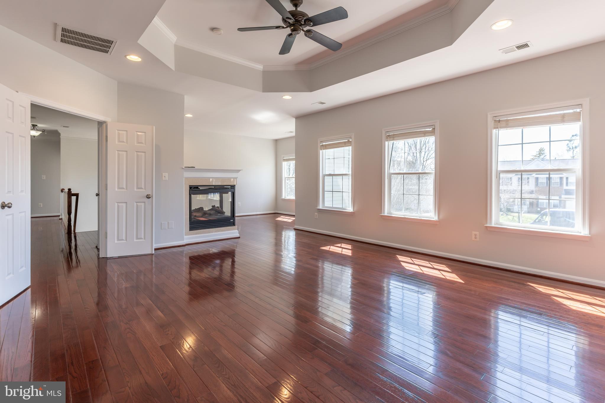 12675 Rushing Creek Court Bristow, VA 20136 - Photo 12 of 49 a view of a livingroom with a ceiling fan window and wooden floor