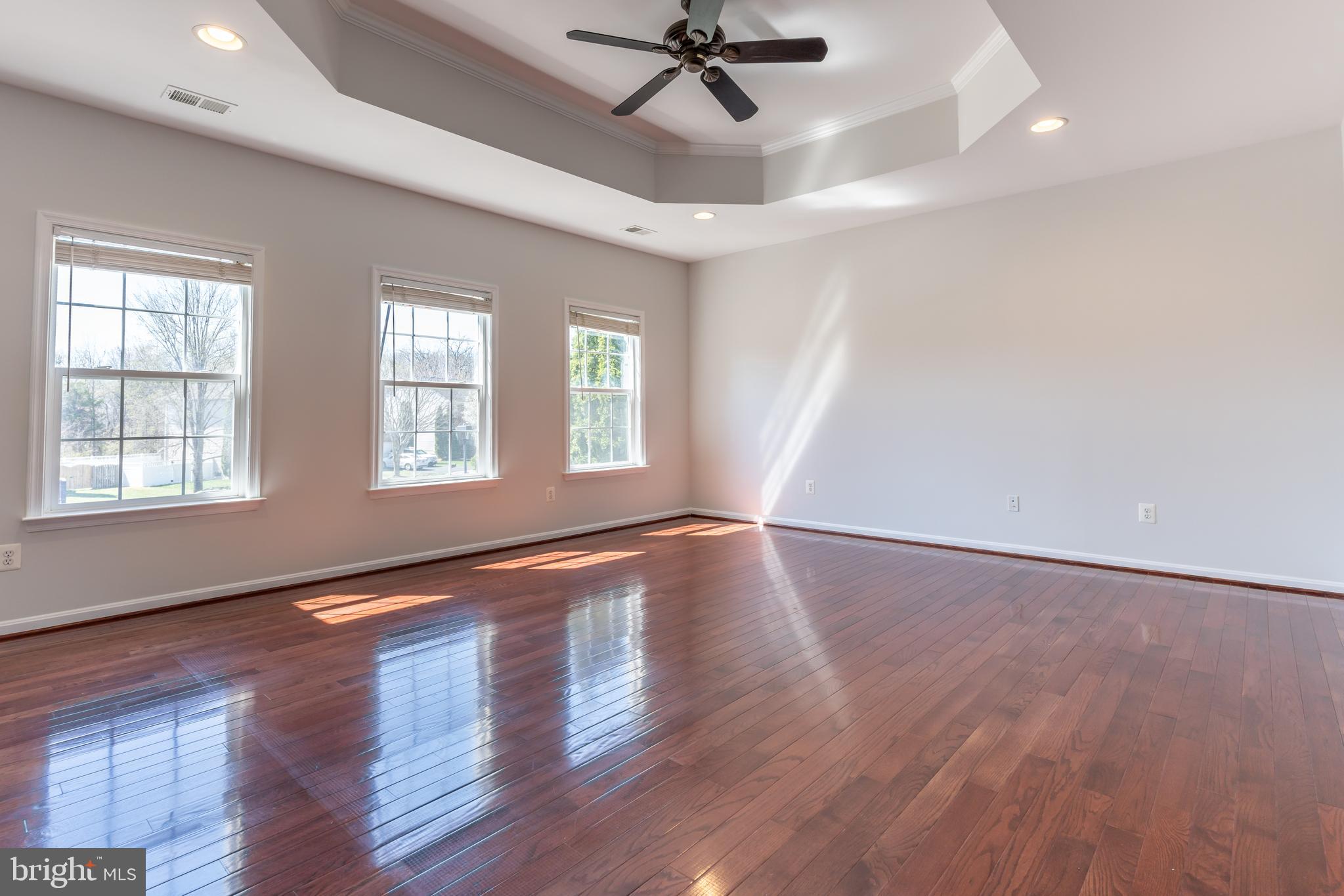 12675 Rushing Creek Court Bristow, VA 20136 - Photo 13 of 49 wooden floor in an empty room with a window