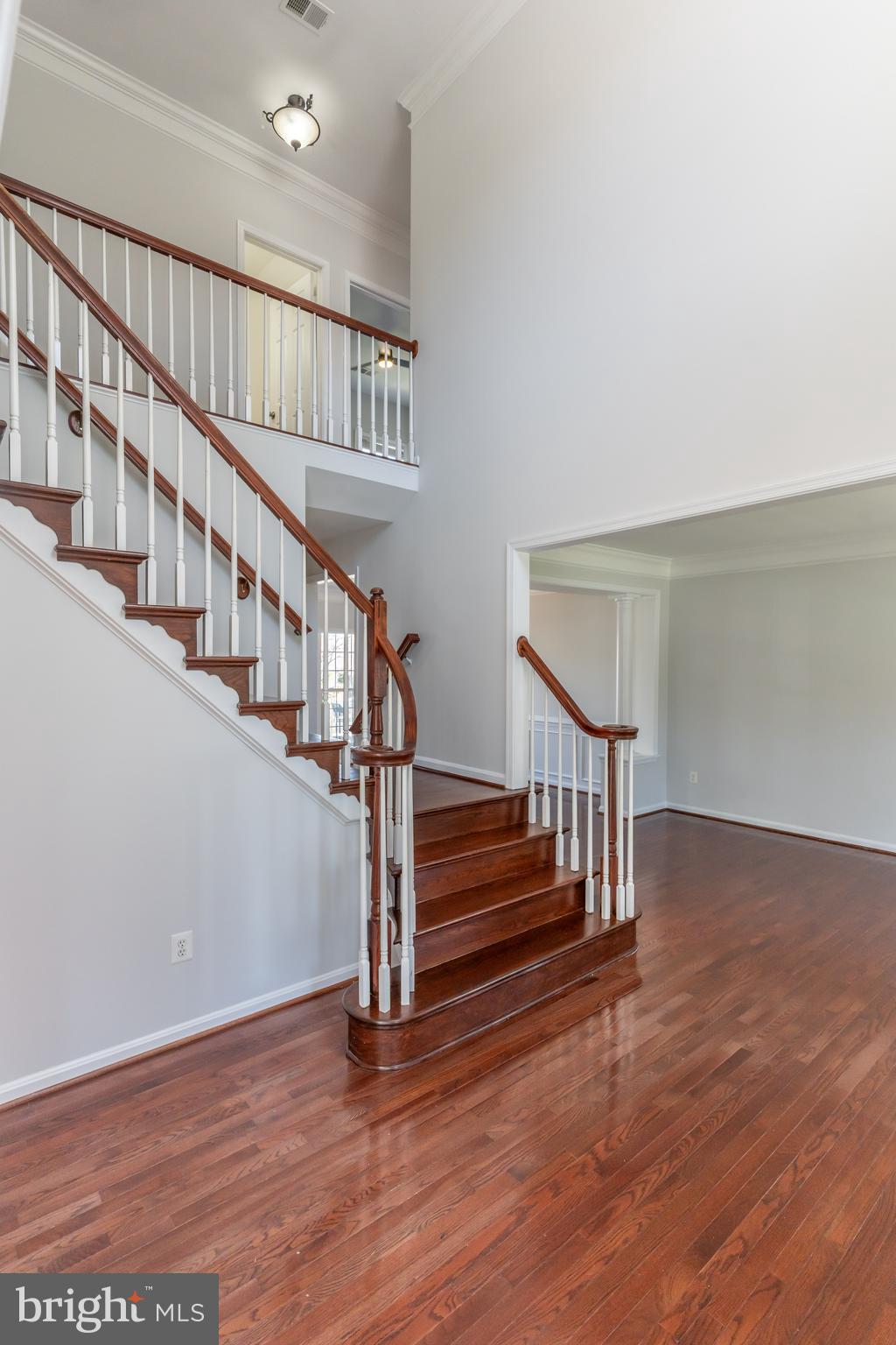 12675 Rushing Creek Court Bristow, VA 20136 - Photo 14 of 49 a view of staircase with wooden floor and white walls