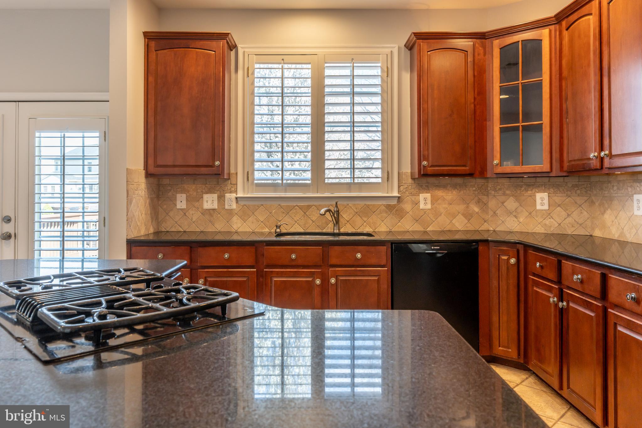 12675 Rushing Creek Court Bristow, VA 20136 - Photo 17 of 49 a kitchen with stainless steel appliances granite countertop a stove a sink and a microwave