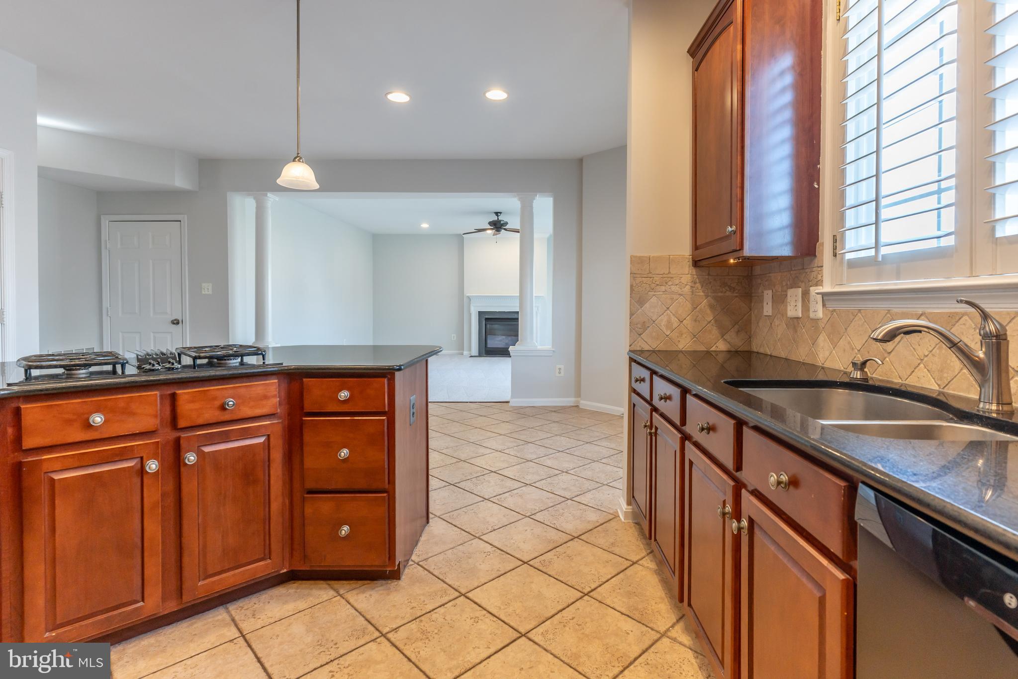 12675 Rushing Creek Court Bristow, VA 20136 - Photo 20 of 49 a kitchen with stainless steel appliances granite countertop a sink and a stove