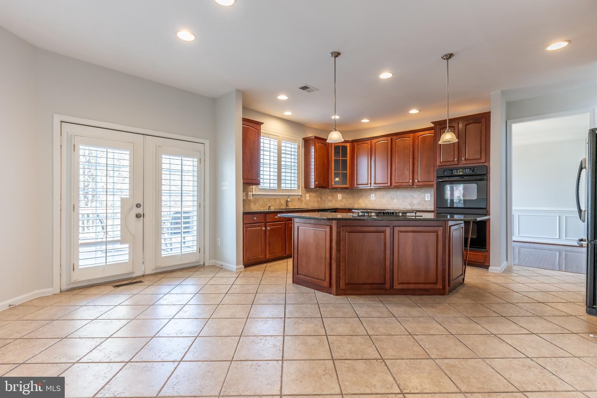 12675 Rushing Creek Court Bristow, VA 20136 - Photo 21 of 49 a kitchen with a sink a counter top space cabinets and stainless steel appliances