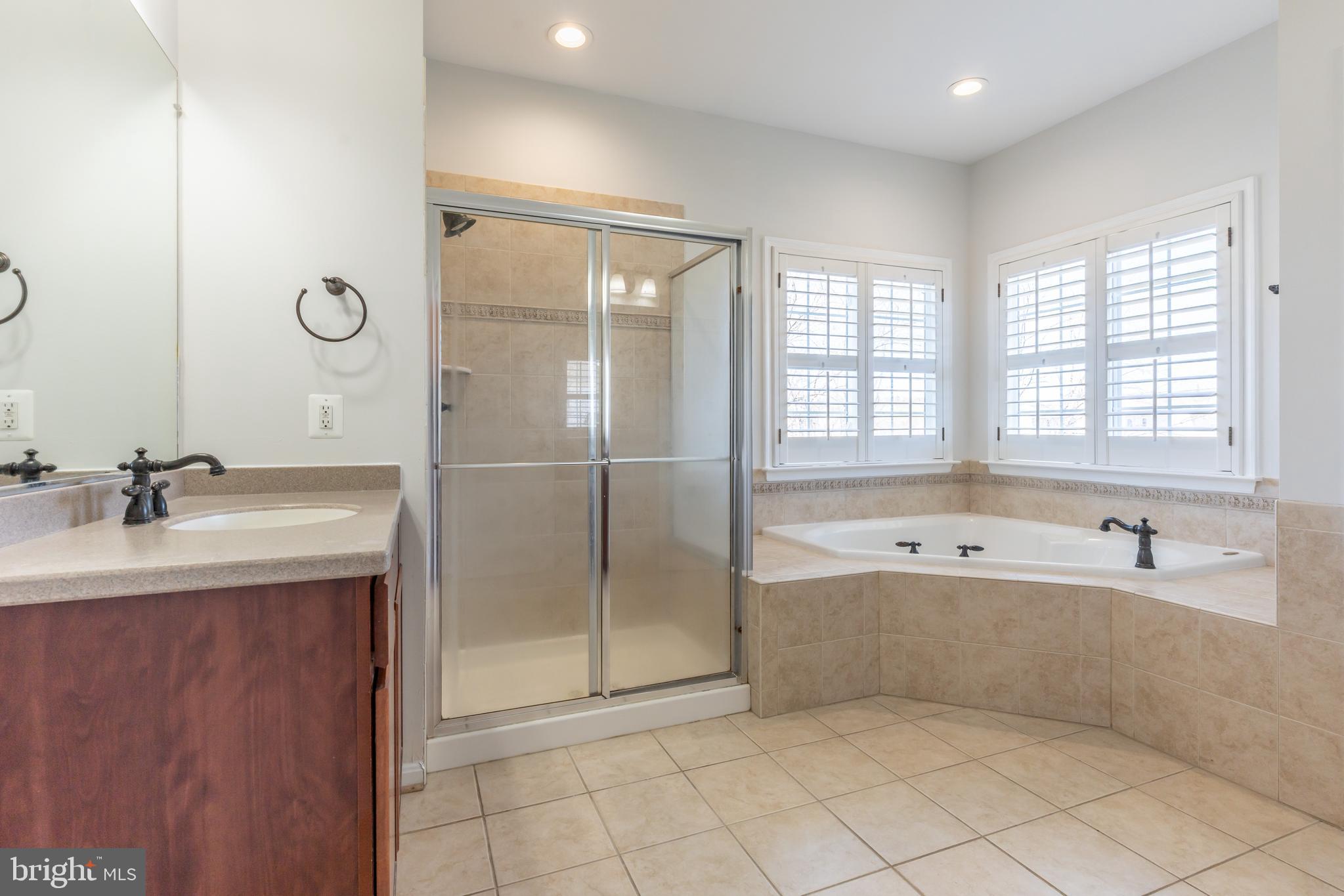 12675 Rushing Creek Court Bristow, VA 20136 - Photo 25 of 49 a spacious bathroom with a tub sink and mirror