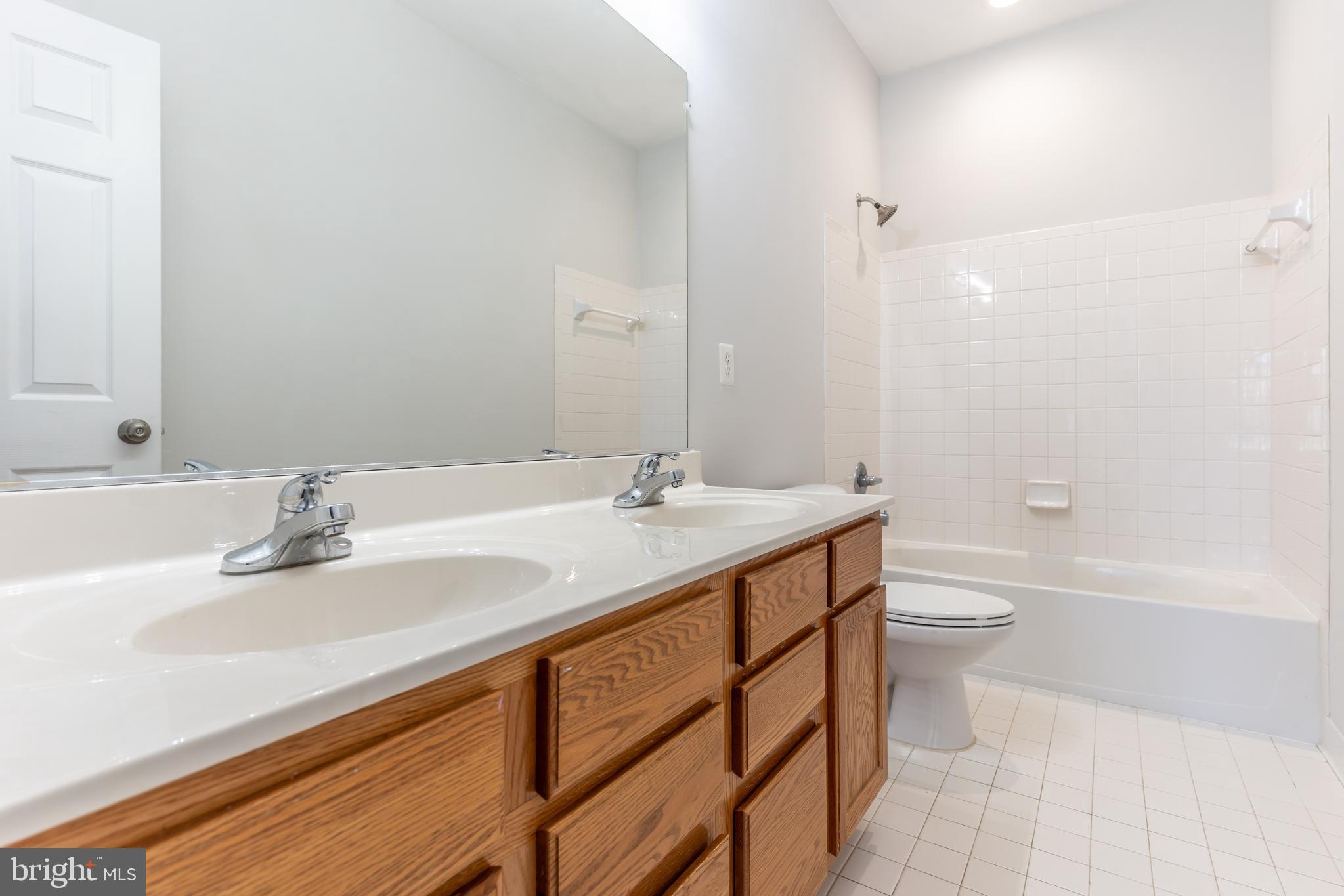 12675 Rushing Creek Court Bristow, VA 20136 - Photo 27 of 49 a bathroom with a sink a toilet and shower