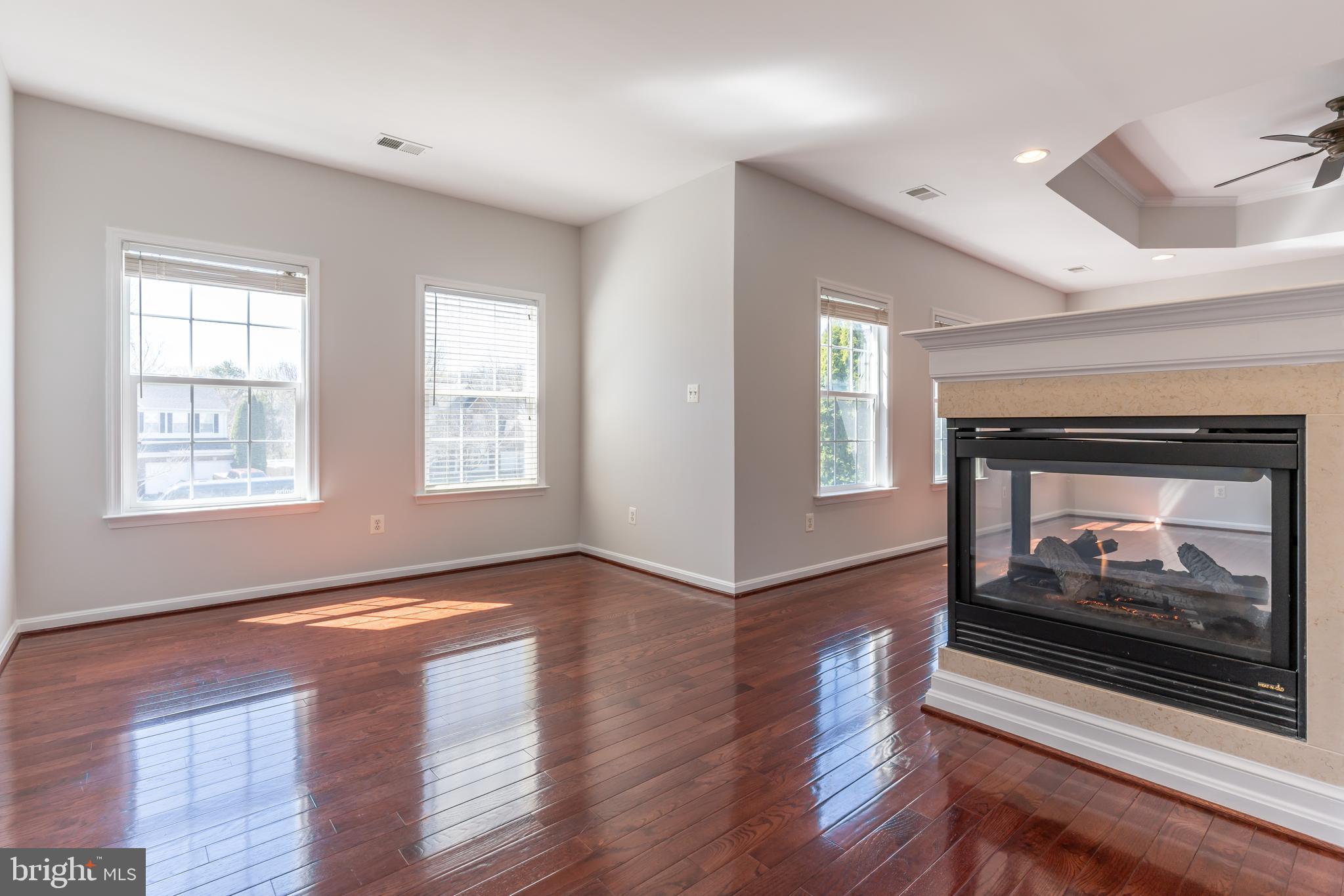 12675 Rushing Creek Court Bristow, VA 20136 - Photo 33 of 49 a view of an empty room with wooden floor and a fireplace