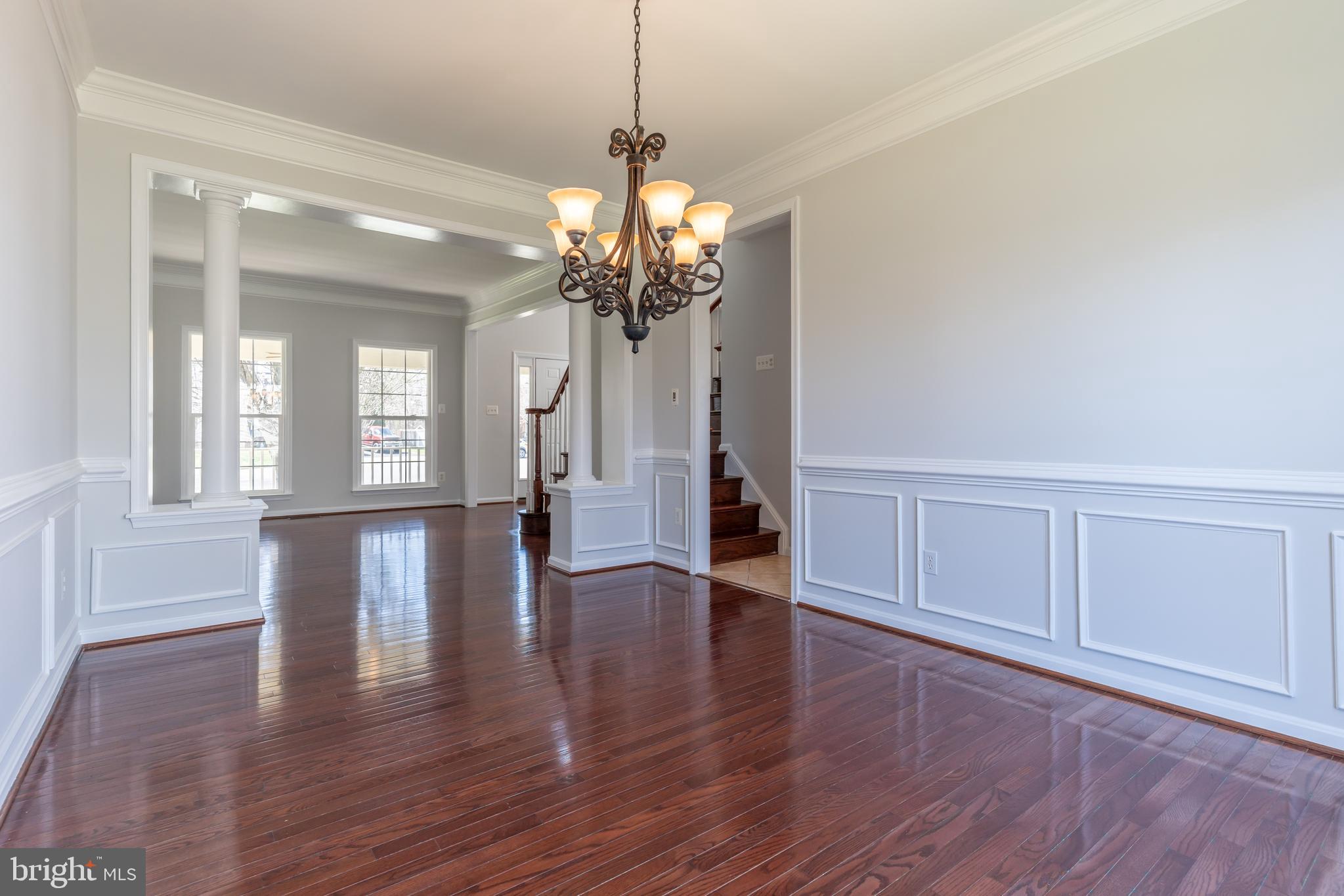 12675 Rushing Creek Court Bristow, VA 20136 - Photo 40 of 49 a view of a room with wooden floor chandelier and windows