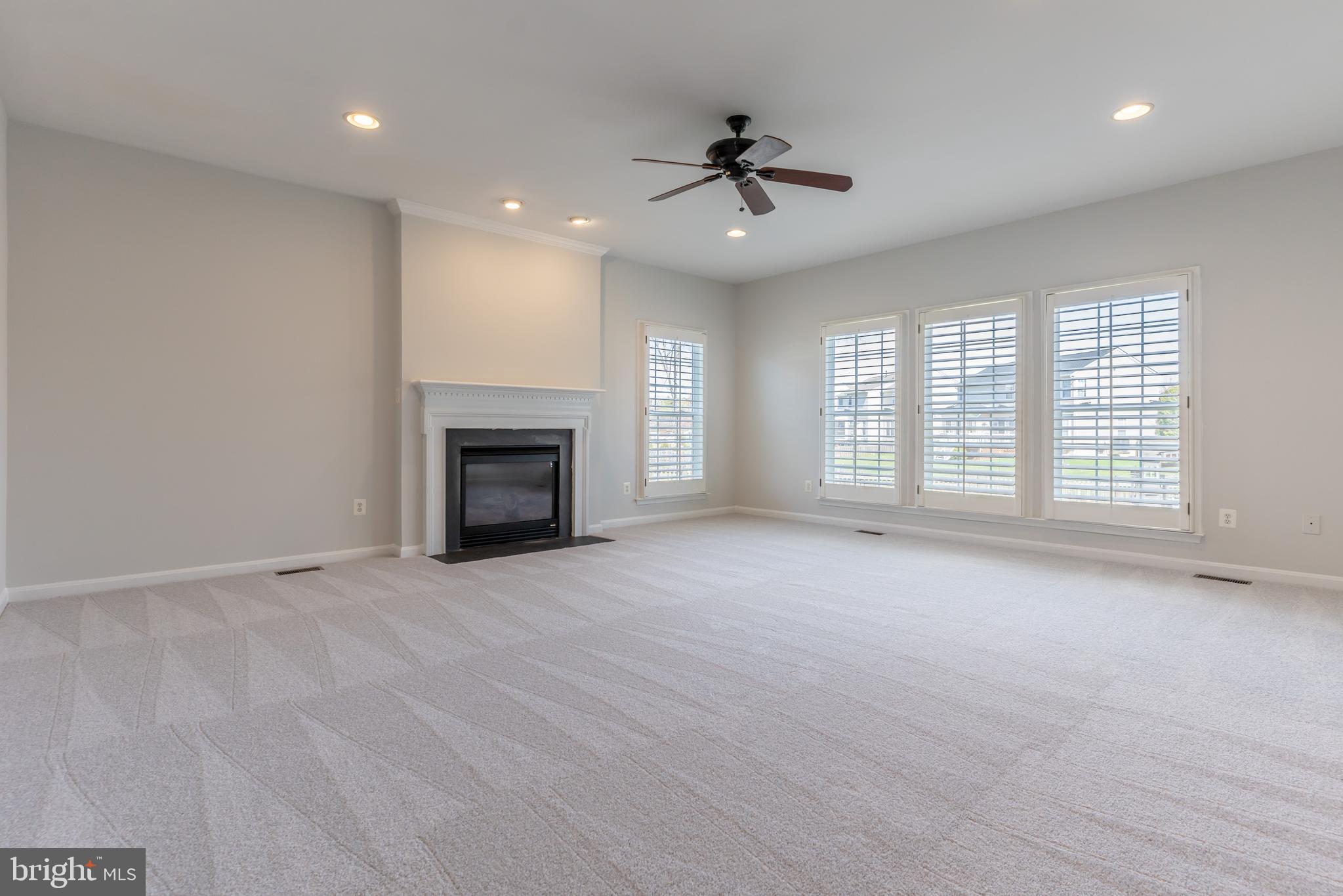 12675 Rushing Creek Court Bristow, VA 20136 - Photo 41 of 49 a view of an empty room with a fireplace and a window