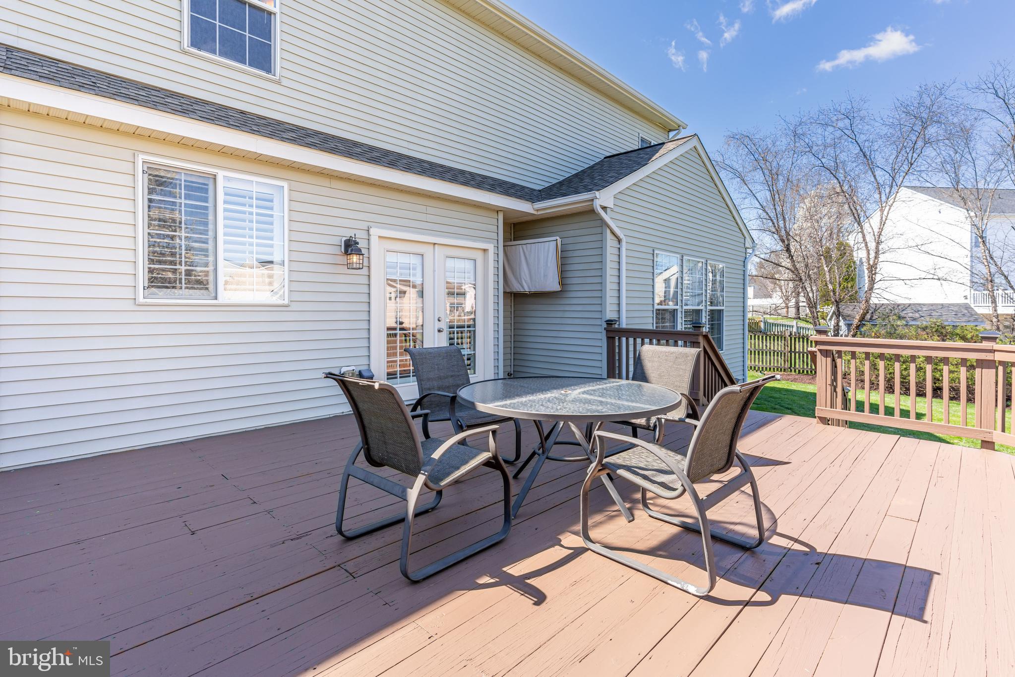 12675 Rushing Creek Court Bristow, VA 20136 - Photo 45 of 49 a patio with table and chairs and potted plants