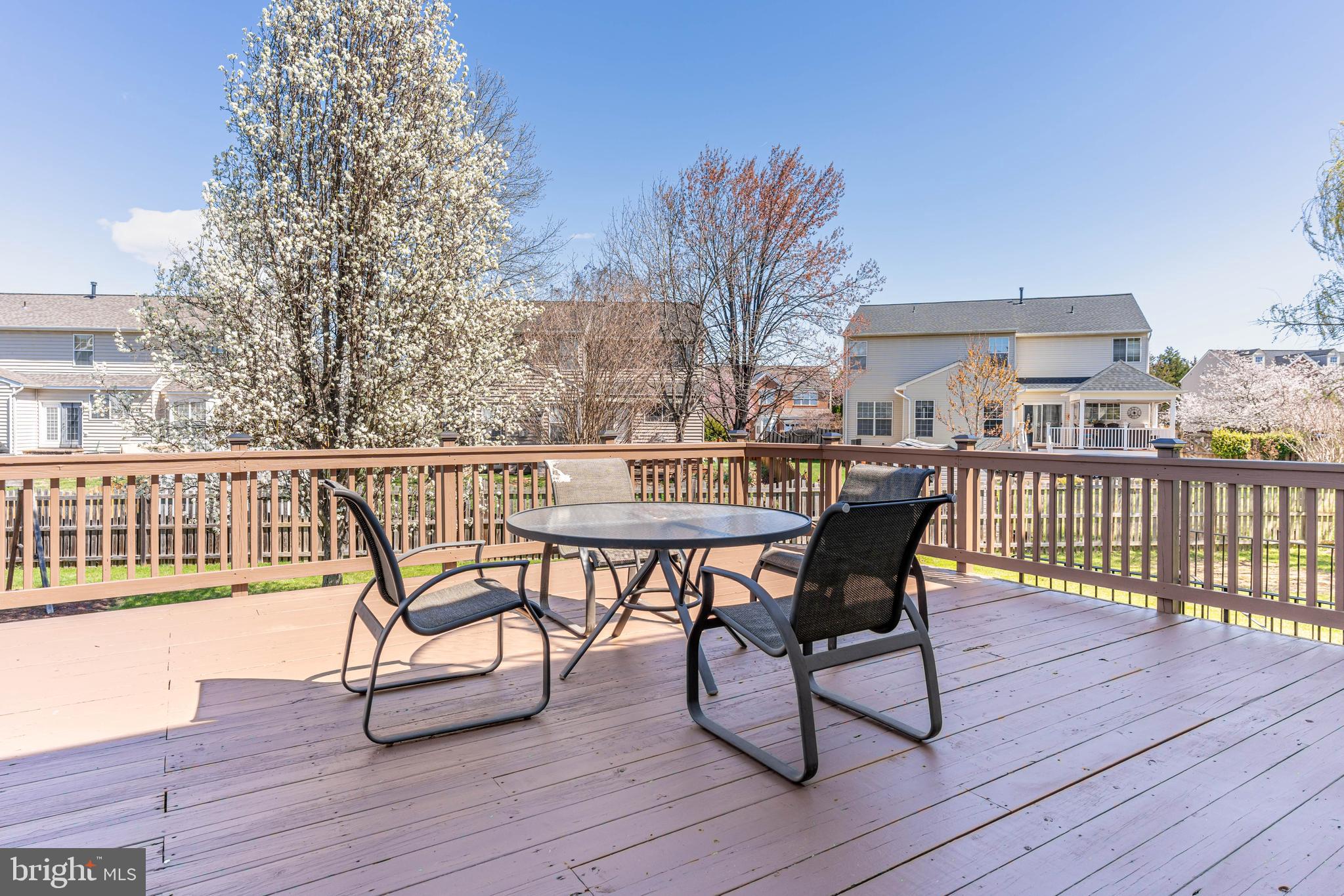 12675 Rushing Creek Court Bristow, VA 20136 - Photo 46 of 49 a view of a roof deck with table and chairs and wooden floor