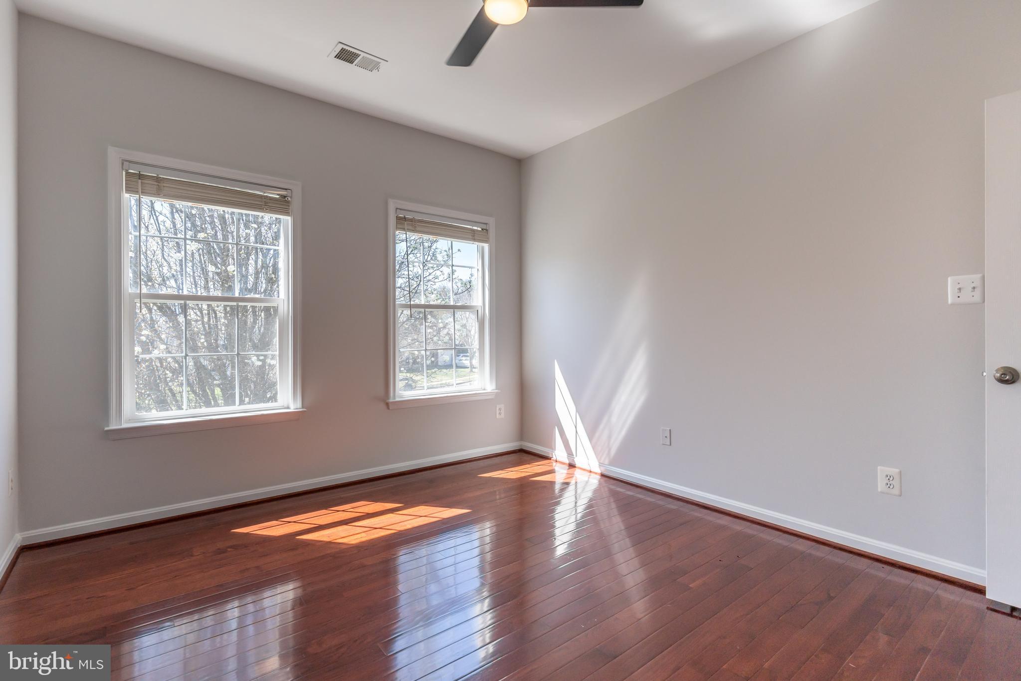 12675 Rushing Creek Court Bristow, VA 20136 - Photo 9 of 49 an empty room with wooden floor and windows