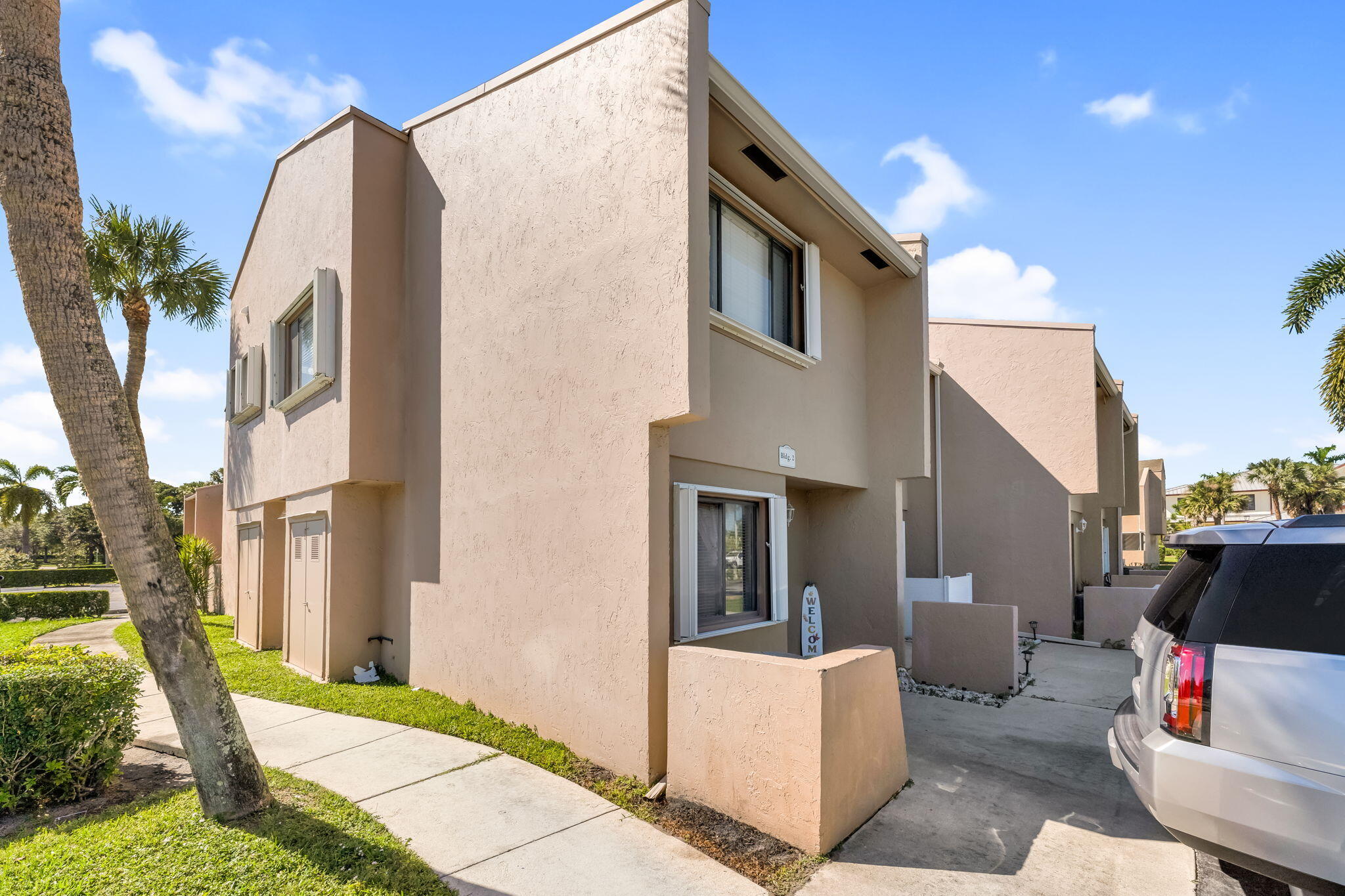 139 Sparrow Drive, Unit 2A Royal Palm Beach, FL 33411 - Photo 1 of 30 a front view of a house with patio