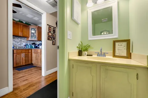 a hallway with sink and mirror
