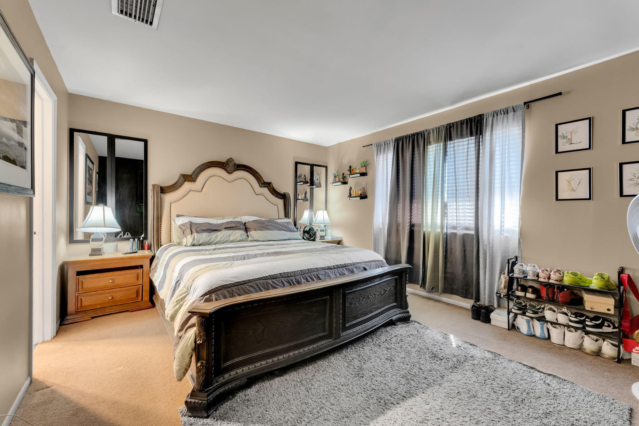 139 Sparrow Drive, Unit 2A Royal Palm Beach, FL 33411 - Photo 18 of 30 a bedroom with a bed and a chandelier