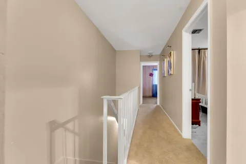 a view of hallway with furniture and entryway