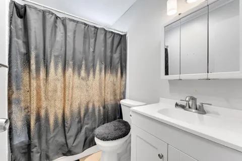 a bathroom with a sink a toilet and a mirror