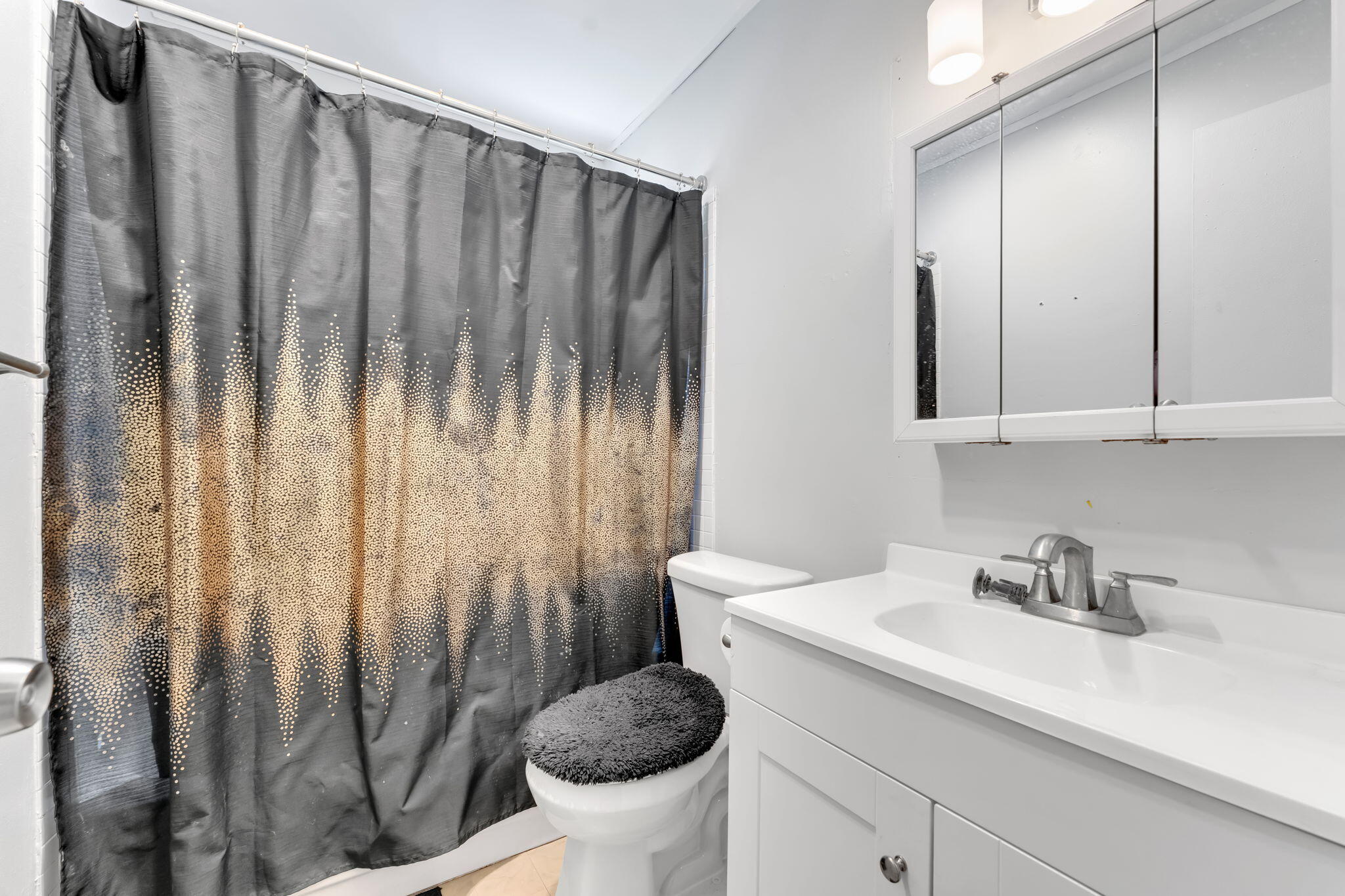 139 Sparrow Drive, Unit 2A Royal Palm Beach, FL 33411 - Photo 24 of 30 a bathroom with a sink a toilet and a mirror