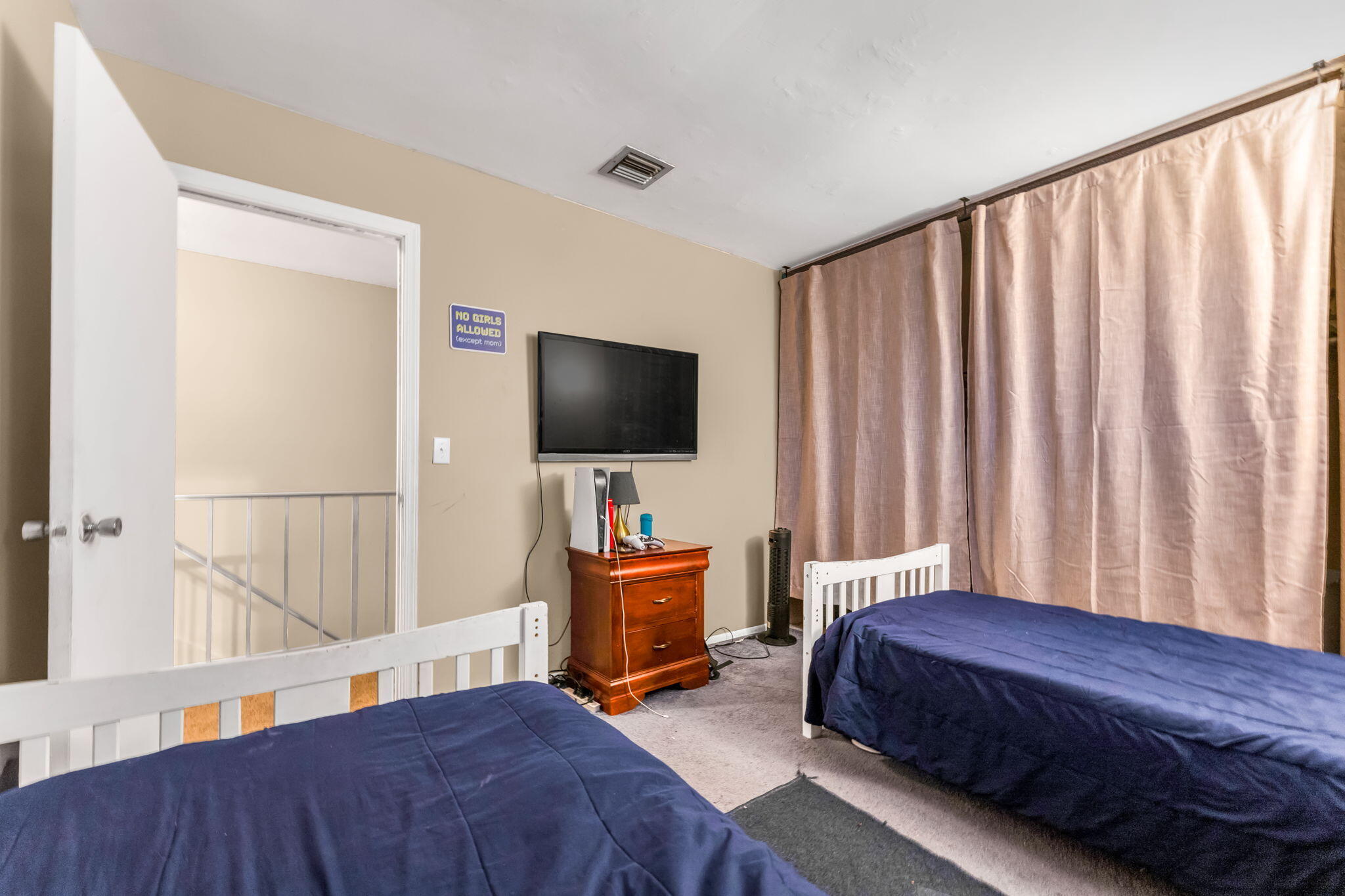 139 Sparrow Drive, Unit 2A Royal Palm Beach, FL 33411 - Photo 26 of 30 a bedroom with a bed and a flat screen tv