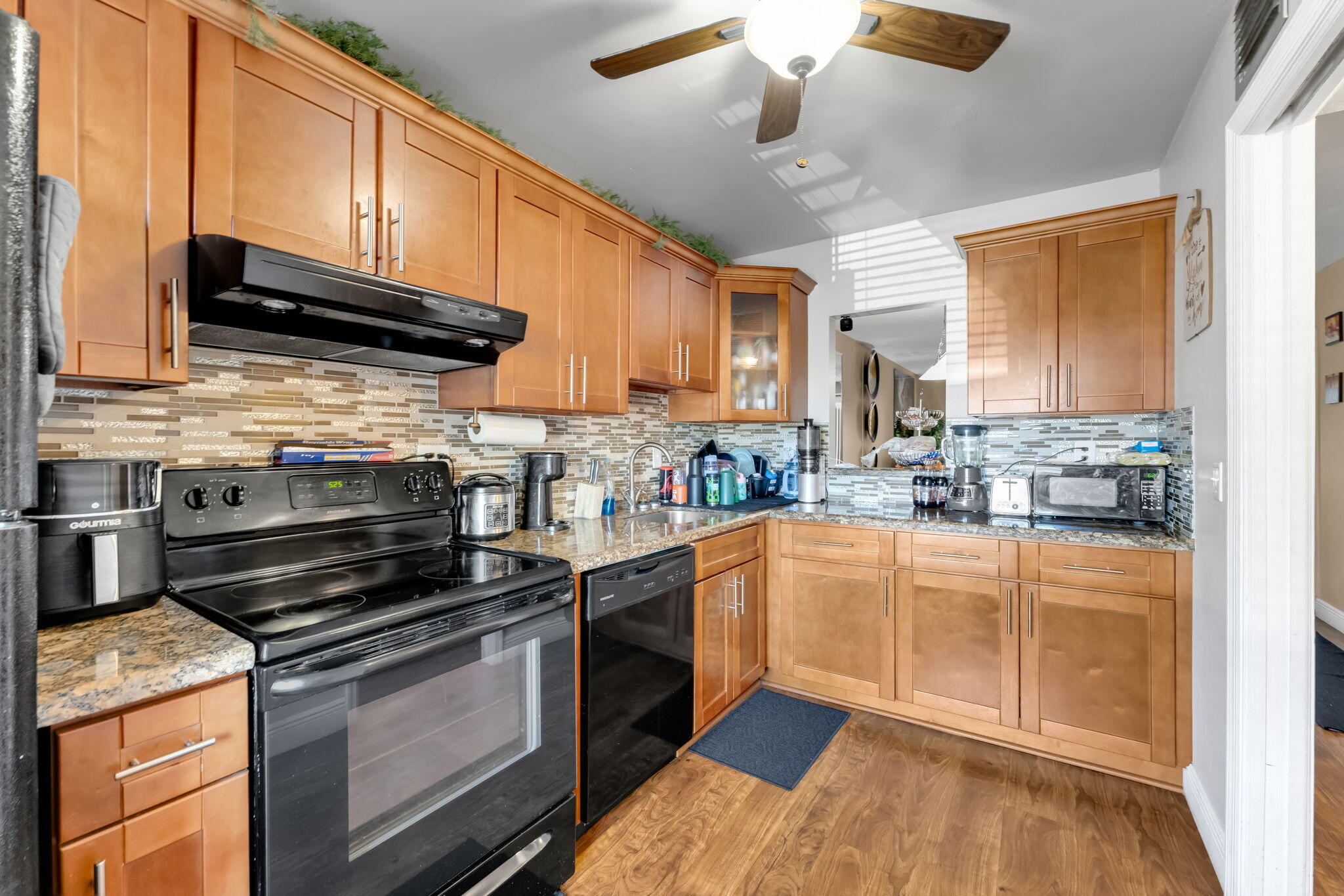 139 Sparrow Drive, Unit 2A Royal Palm Beach, FL 33411 - Photo 6 of 30 a kitchen with stainless steel appliances granite countertop a stove a sink and a microwave