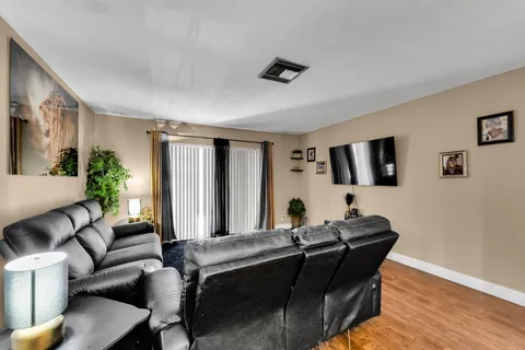 a living room with furniture and wooden floor