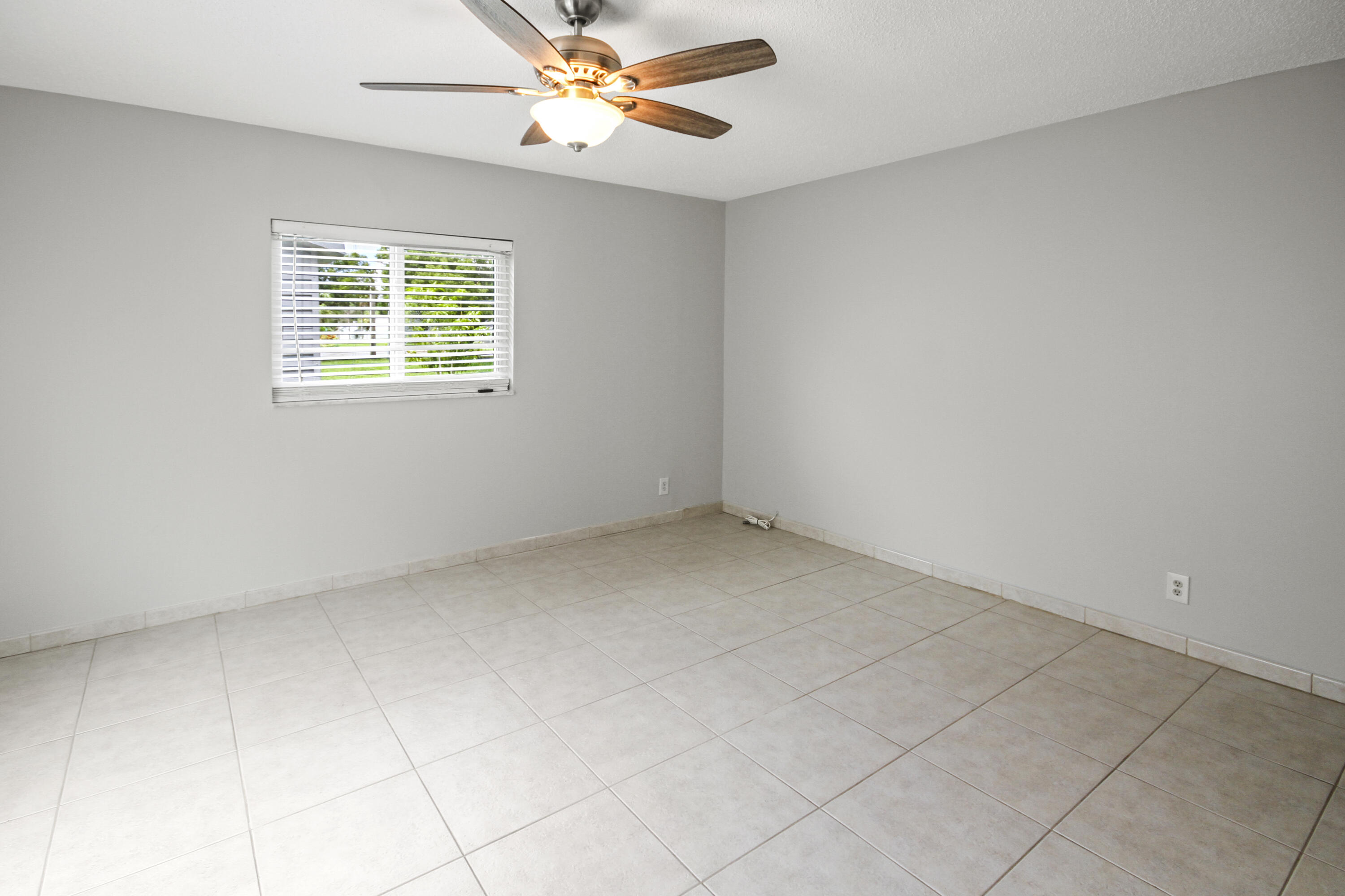 22493 Southwest 56th Avenue Boca Raton, FL 33433 - Photo 13 of 31 an empty room with windows and fan