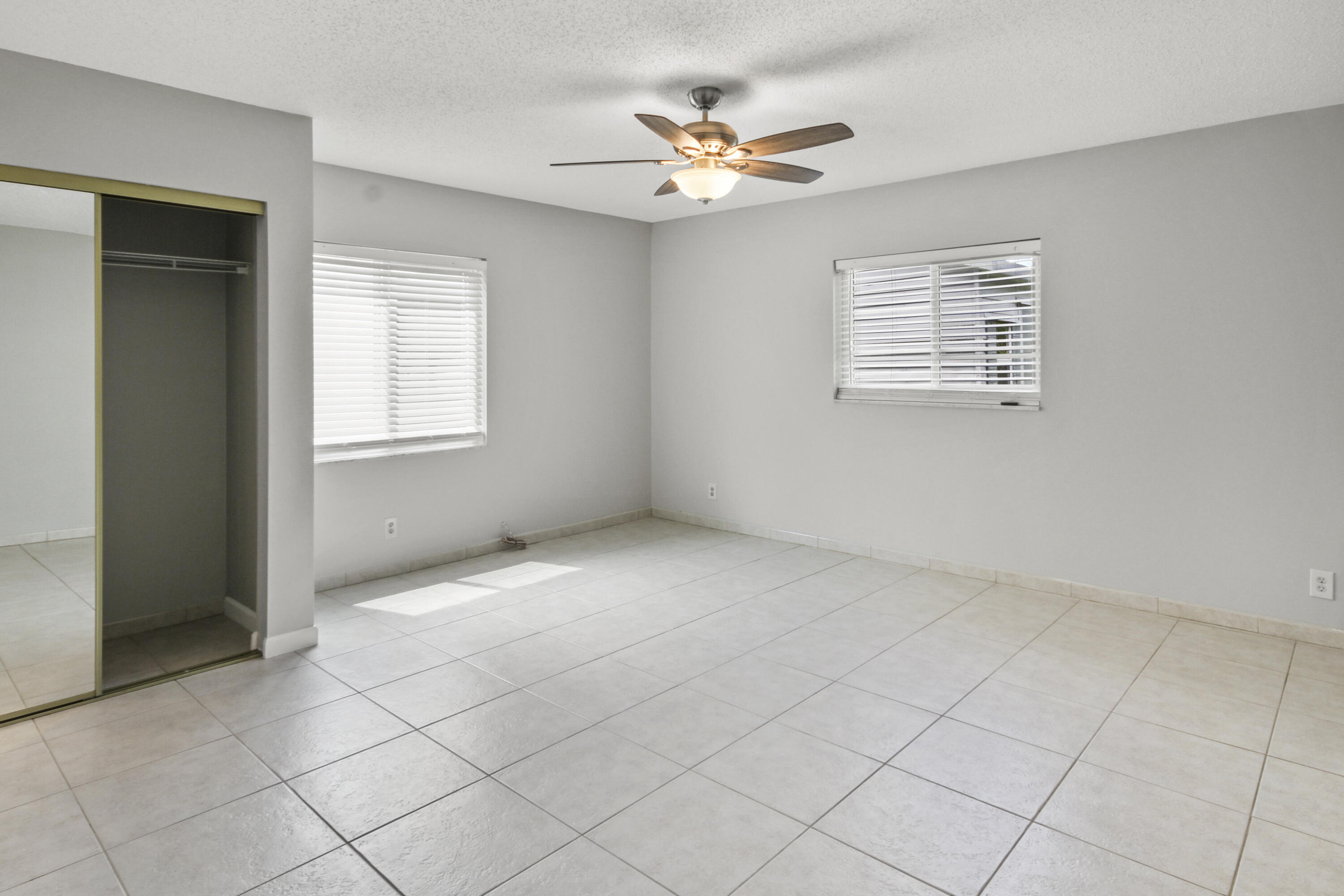 22493 Southwest 56th Avenue Boca Raton, FL 33433 - Photo 15 of 31 an empty room with windows and fan