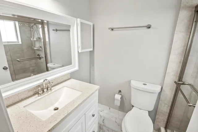 a bathroom with a sink toilet and shower