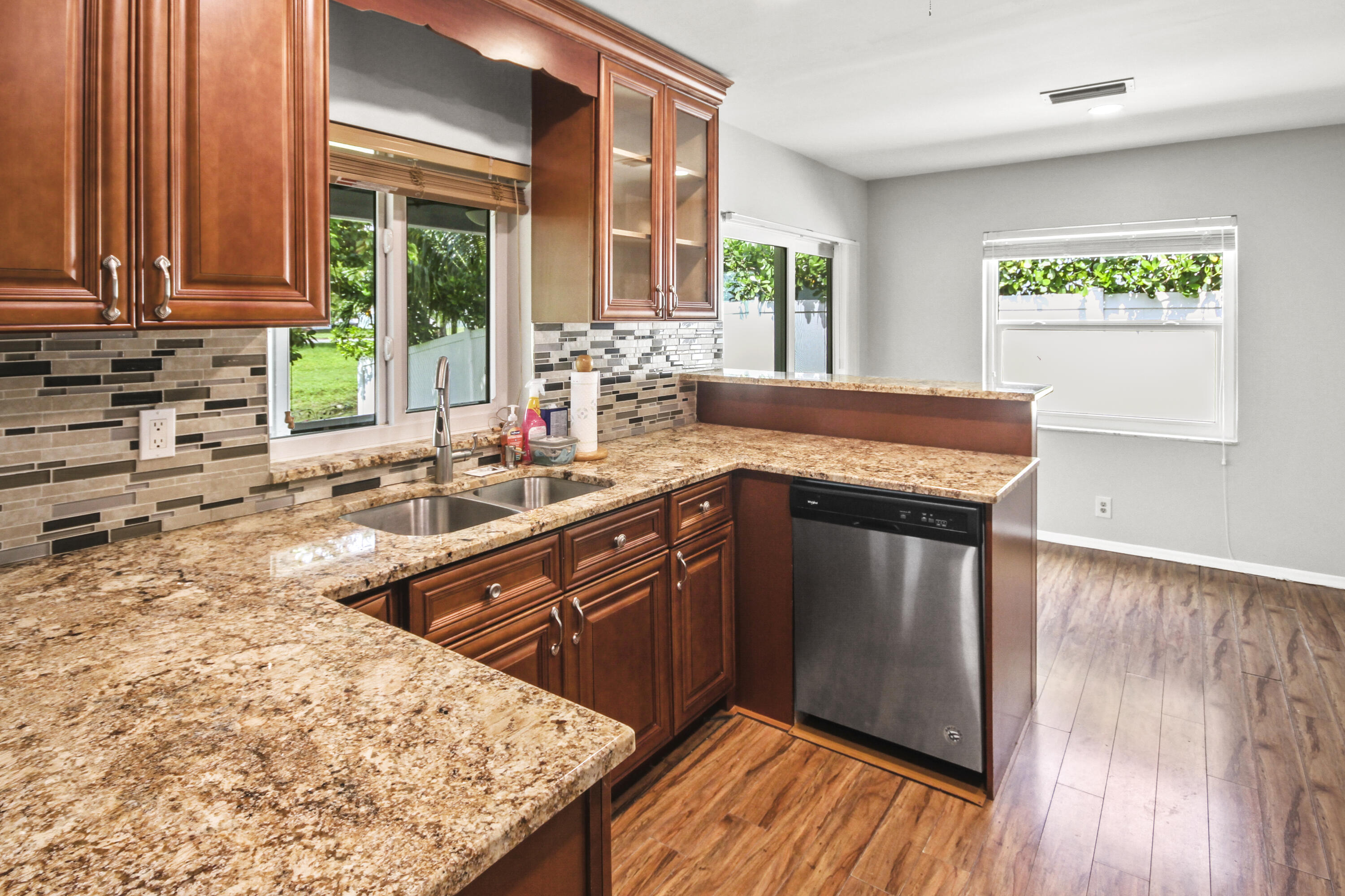 22493 Southwest 56th Avenue Boca Raton, FL 33433 - Photo 20 of 31 a kitchen with stainless steel appliances granite countertop a sink stove and cabinets