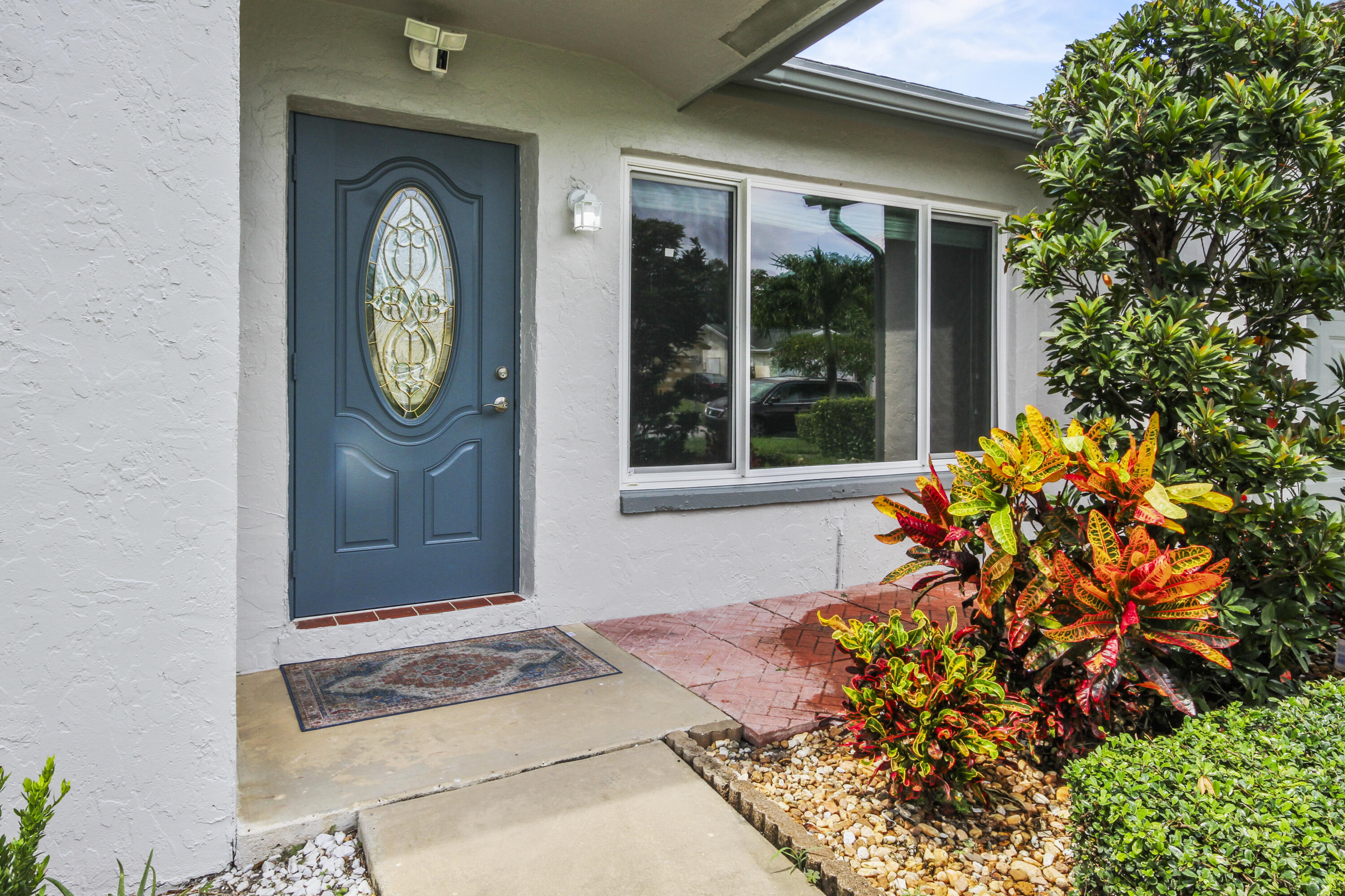 22493 Southwest 56th Avenue Boca Raton, FL 33433 - Photo 2 of 31 a front view of a house with garden